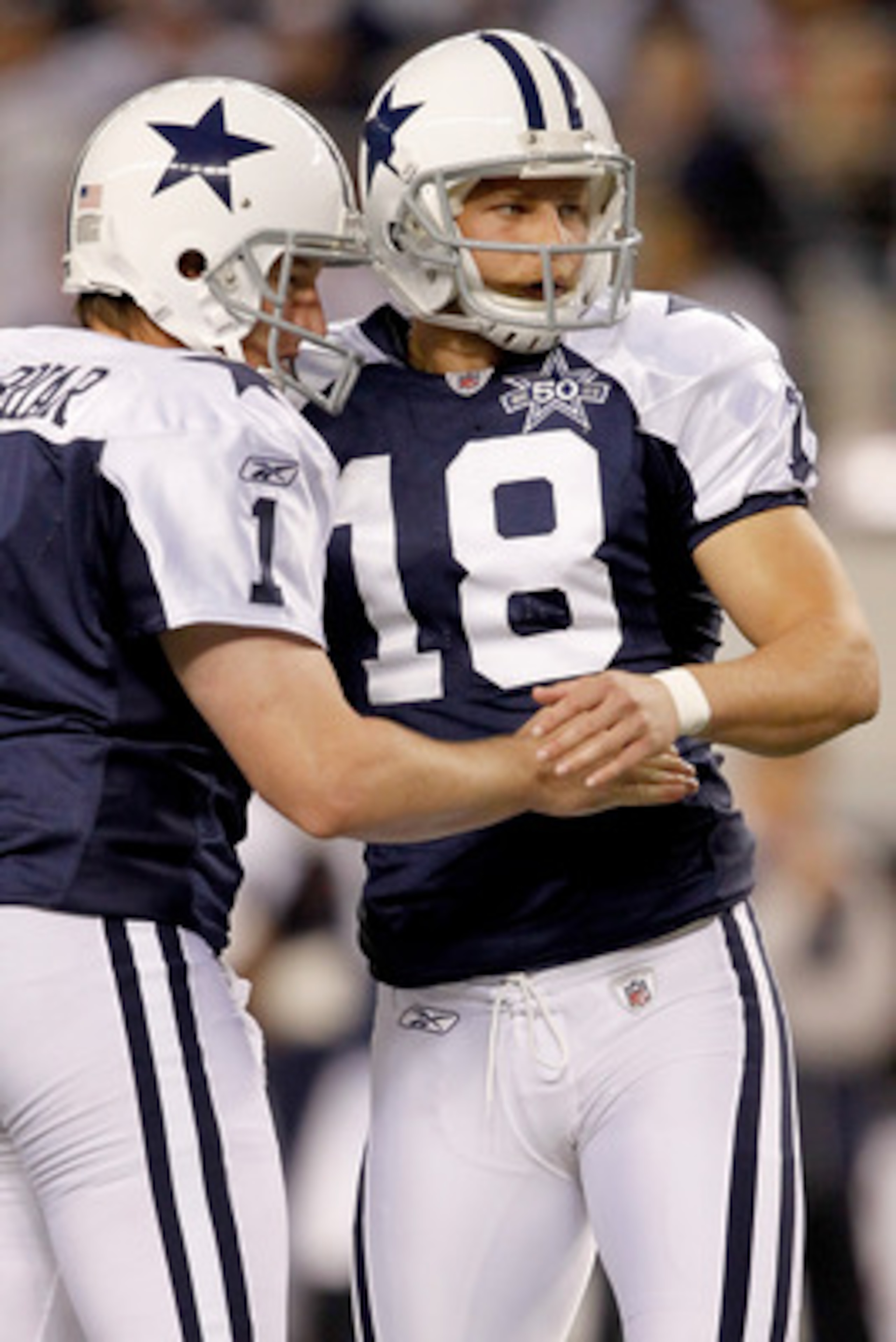 ARLINGTON, TX - NOVEMBER 25:  David Buehler #18 of the Dallas Cowboys is congratulated by Matt McBriar #1 after kicking a field goal against the New Orleans Saints at Cowboys Stadium on November 25, 2010 in Arlington, Texas.  (Photo by Matthew Stockman/Ge