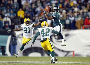 PHILADELPHIA - JANUARY 11: Wide receiver Freddie Mitchell #84 of the Philadelphia Eagles catches a 28-yard catch on defensive backs Jue Bhawoh #21 and Darren Sharper #42 of the Green Bay Packers on the Eagles last posession in the forth quarter during th PHILADELPHIA - JANUARY 11: Wide receiver Freddie Mitchell #84 of the Philadelphia Eagles catches a 28-yard catch on defensive backs Jue Bhawoh #21 and Darren Sharper #42 of the Green Bay Packers on the Eagles last posession in the forth quarter during th