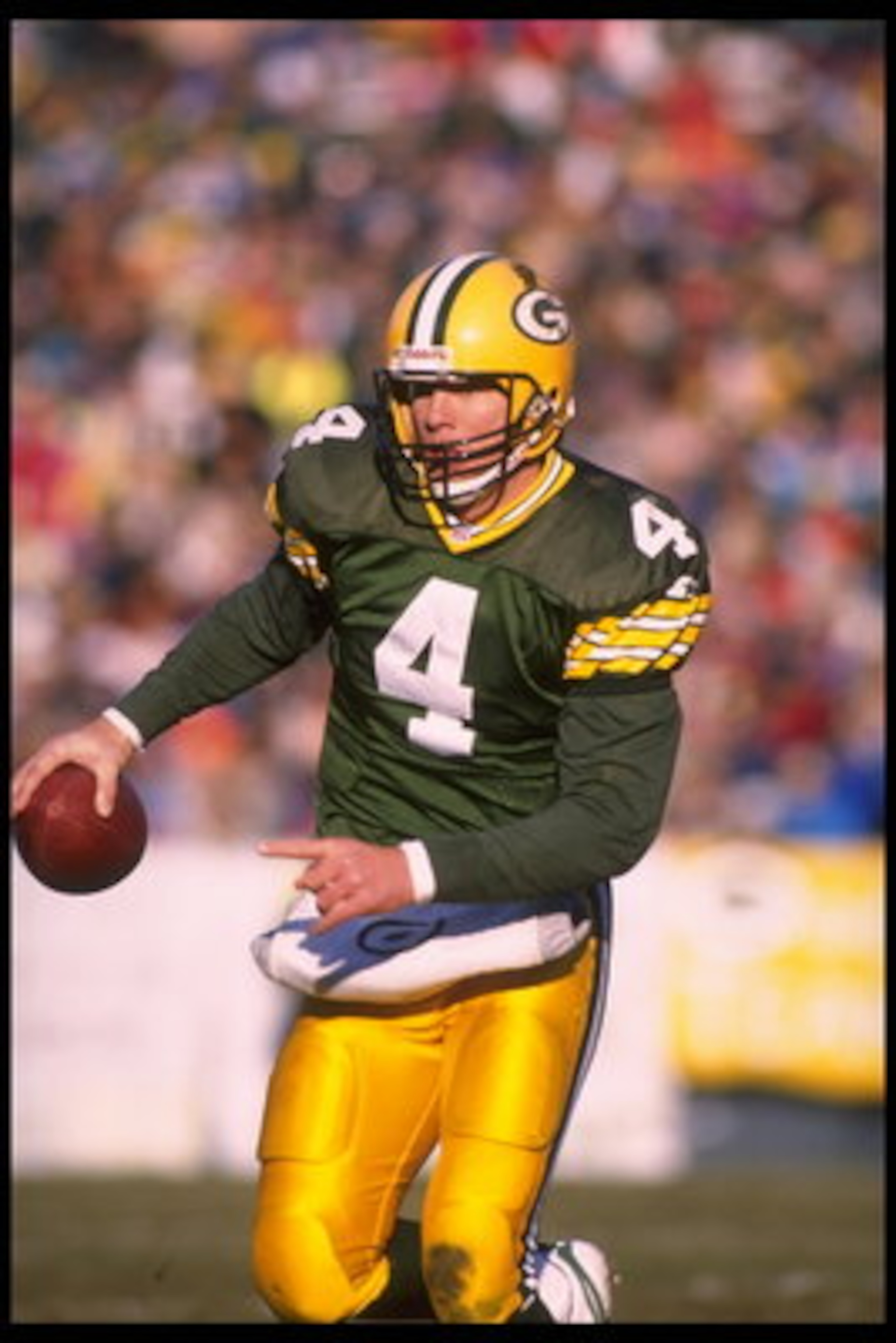 3 Dec 1995:  Quarterback Brett Favre #4 of the Green Bay Packers scrambles out of the pocket and scans the field for a receiver during the game against the Cincinnati Bengals at Lambeau Field in Green Bay, Wisconsin.  The Packers defeated the Bengals 24-1