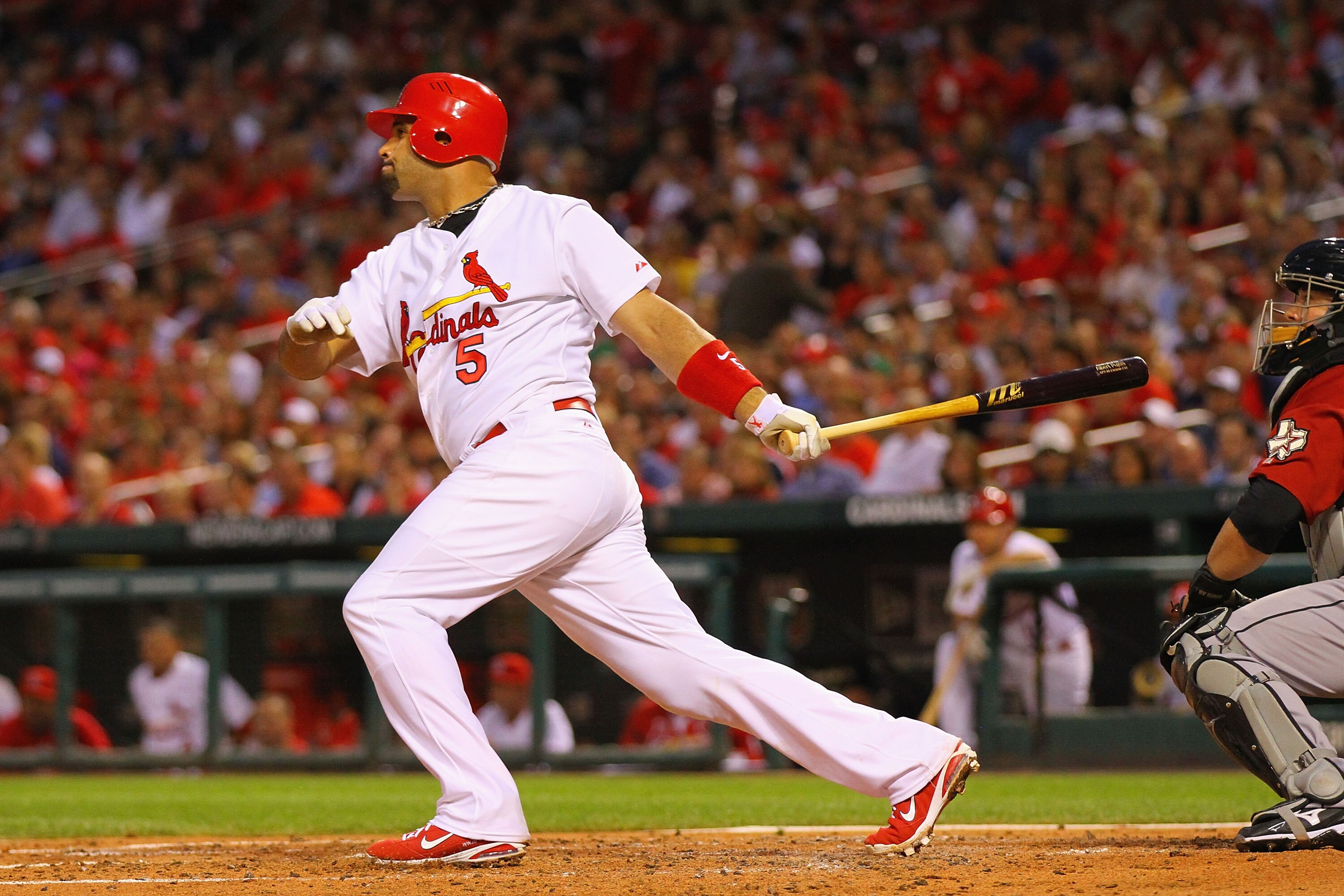 ST. LOUIS, MO - MAY 18: Albert Pujols #5 of the St.Louis Cardinals hits an RBI single against the Houston Astros at Busch Stadium on May 18, 2011 in St. Louis, Missouri.  (Photo by Dilip Vishwanat/Getty Images)