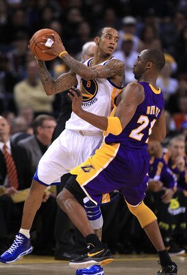 OAKLAND, CA - JANUARY 12: Kobe Bryant #24 of the Los Angeles Lakers plays tight defense on Monta Ellis #8 of the Golden State Warriors at Oracle Arena on January 12, 2011 in Oakland, California. NOTE TO USER: User expressly acknowledges and agrees that, b