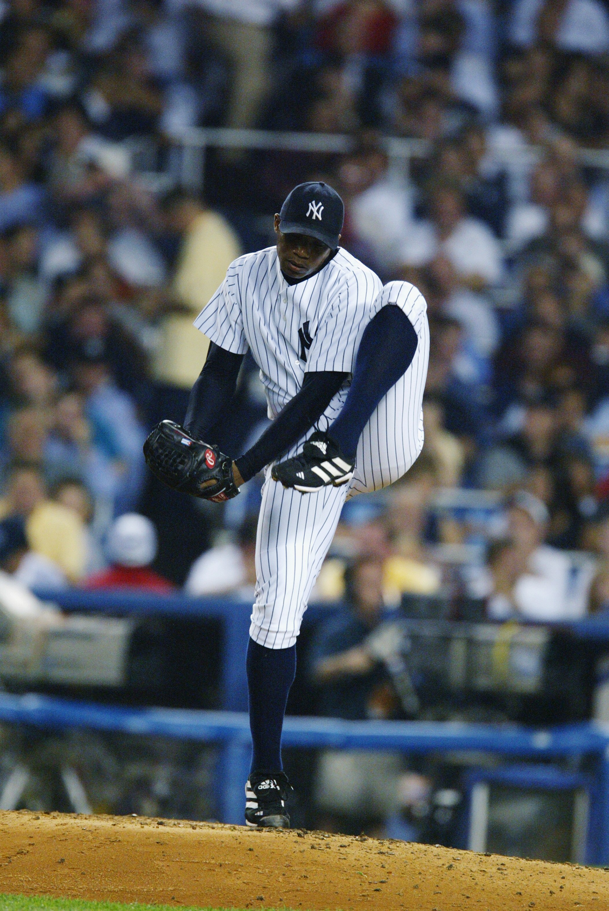 BRONX, NY - OCTOBER 2:   Orlando Hernandez #26 of the New York Yankees winds up the pitch during game two of the American League Division Series against the Anaheim Angels at Yankee Stadium in the Bronx, New York on October 2, 2002.  The Angels defeated t