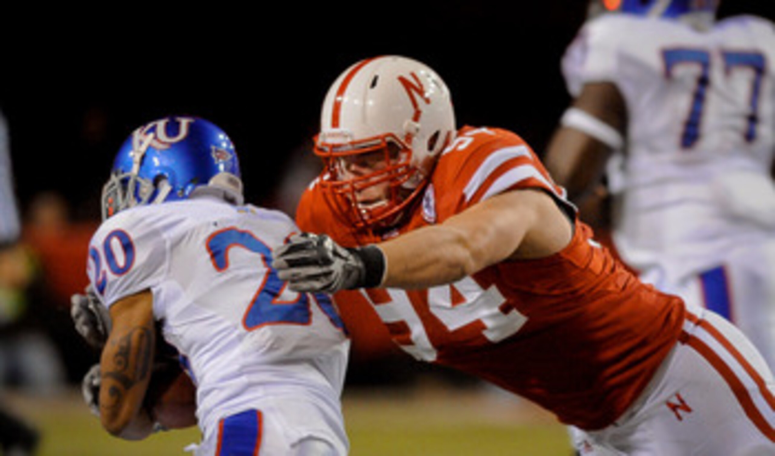 LINCOLN, NE - NOVEMBER 13: Jared Crick #94 of the Nebraska Cornhuskers runs down D.J. Beshears #20 of the Kansas Jayhawks during first half action of their game at Memorial Stadium on November 13, 2010 in Lincoln, Nebraska.  (Photo by Eric Francis/Getty I
