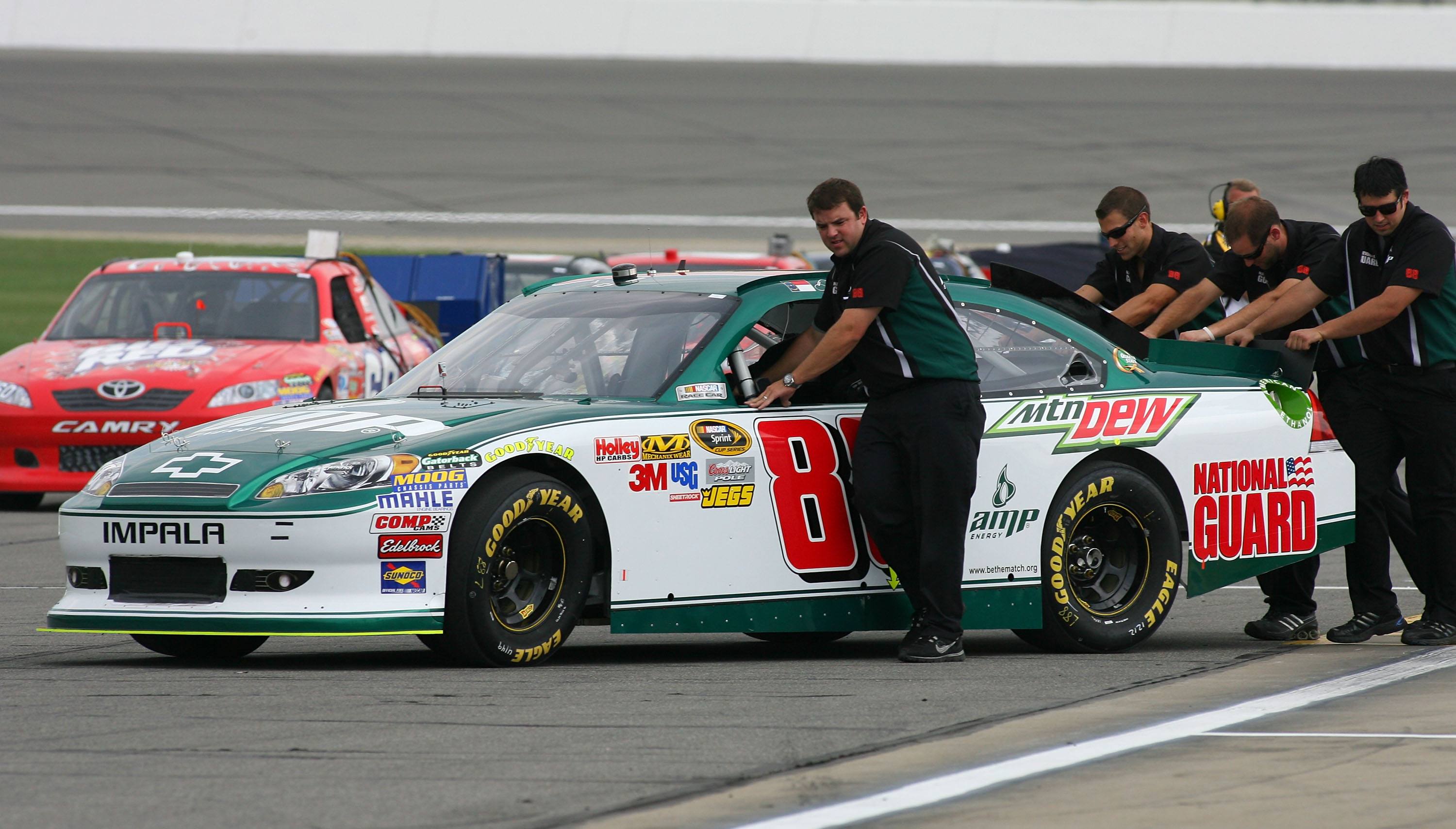 KANSAS CITY, KS - JUNE 04:  The #88 Amp Energy/National Guard Chevrolet of Dale Earnhardt Jr. is pushed on to the grid during qualifying for the NASCAR Sprint Cup Series STP 400 at Kansas Speedway on June 4, 2011 in Kansas City, Kansas.  (Photo by Tim Ump
