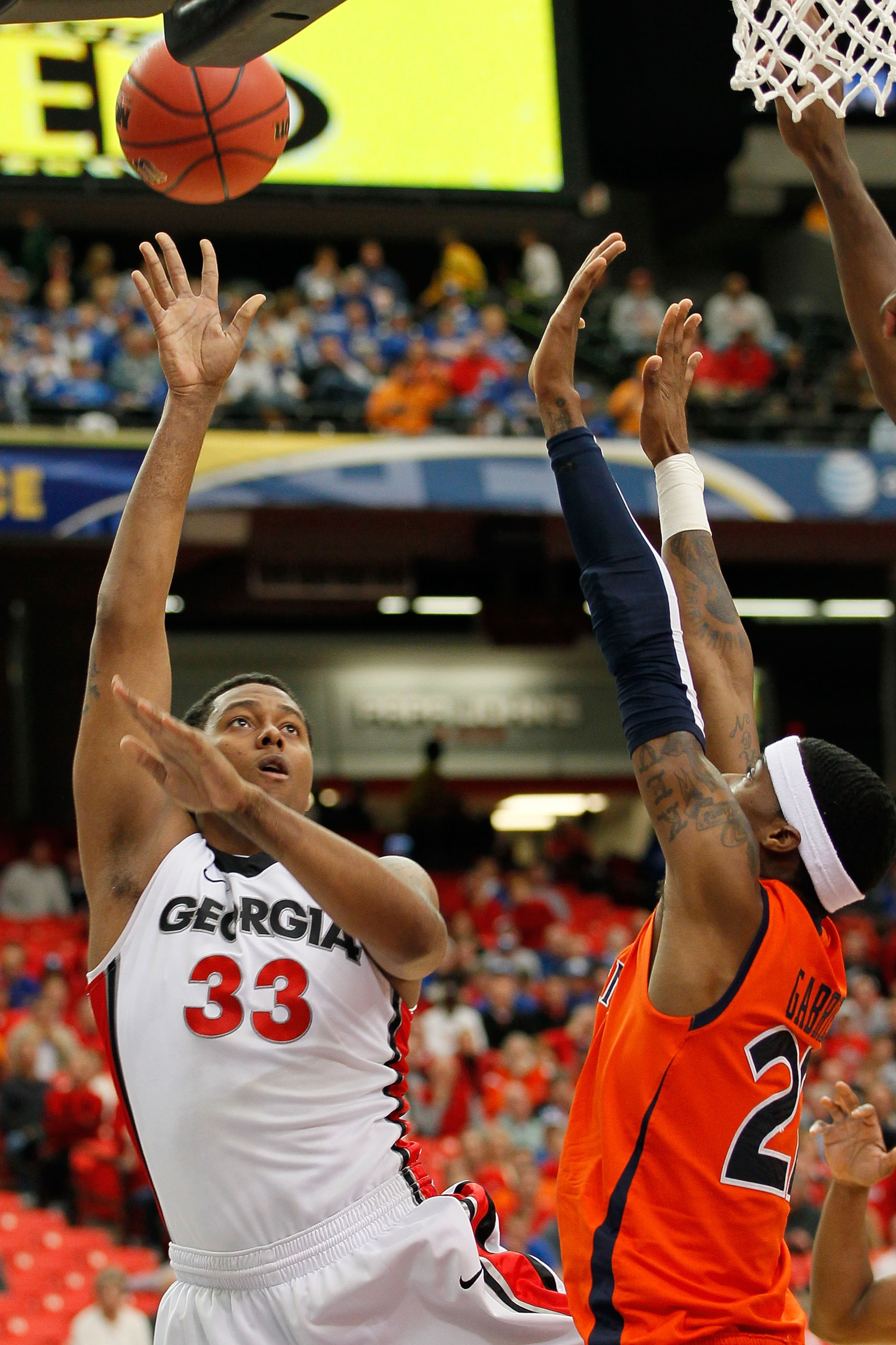 ATLANTA, GA - MARCH 10:  Trey Thompkins #33 of the Georgia Bulldogs shoots over Kenny Gabriel #22 of the Auburn Tigers during the the first round of the SEC Men's Basketball Tournament at the Georgia Dome on March 10, 2011 in Atlanta, Georgia.  (Photo by