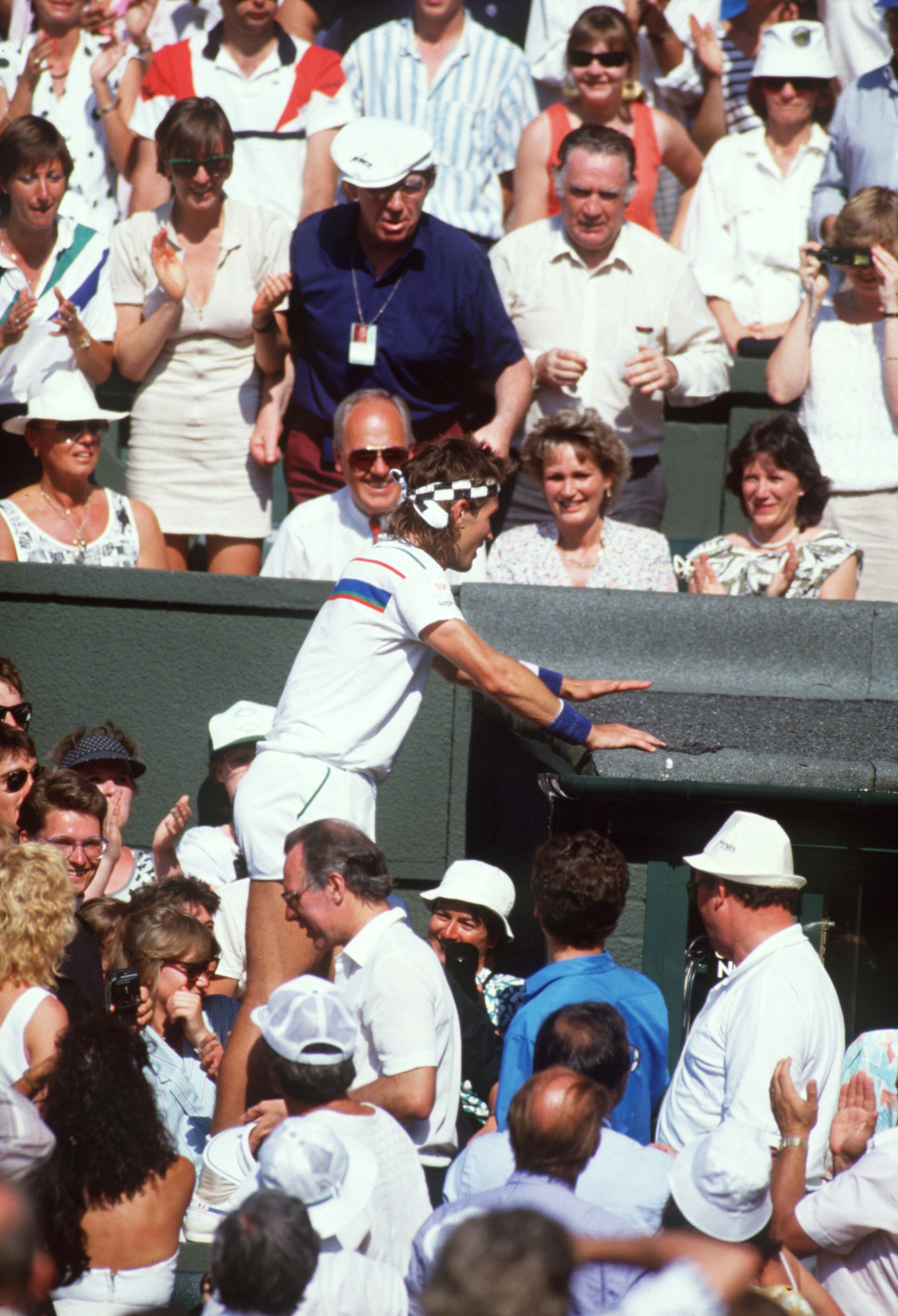 WIMBLEDON JULY:  Pat Cash of Australia in climbs into the crowd after winning the Men's singles final against Ivan Lendl at the All Lawn Tennis Championships held in Wimbledon,London in July 1987.Pat Cash went on to win the title.(Photo by Getty Images)