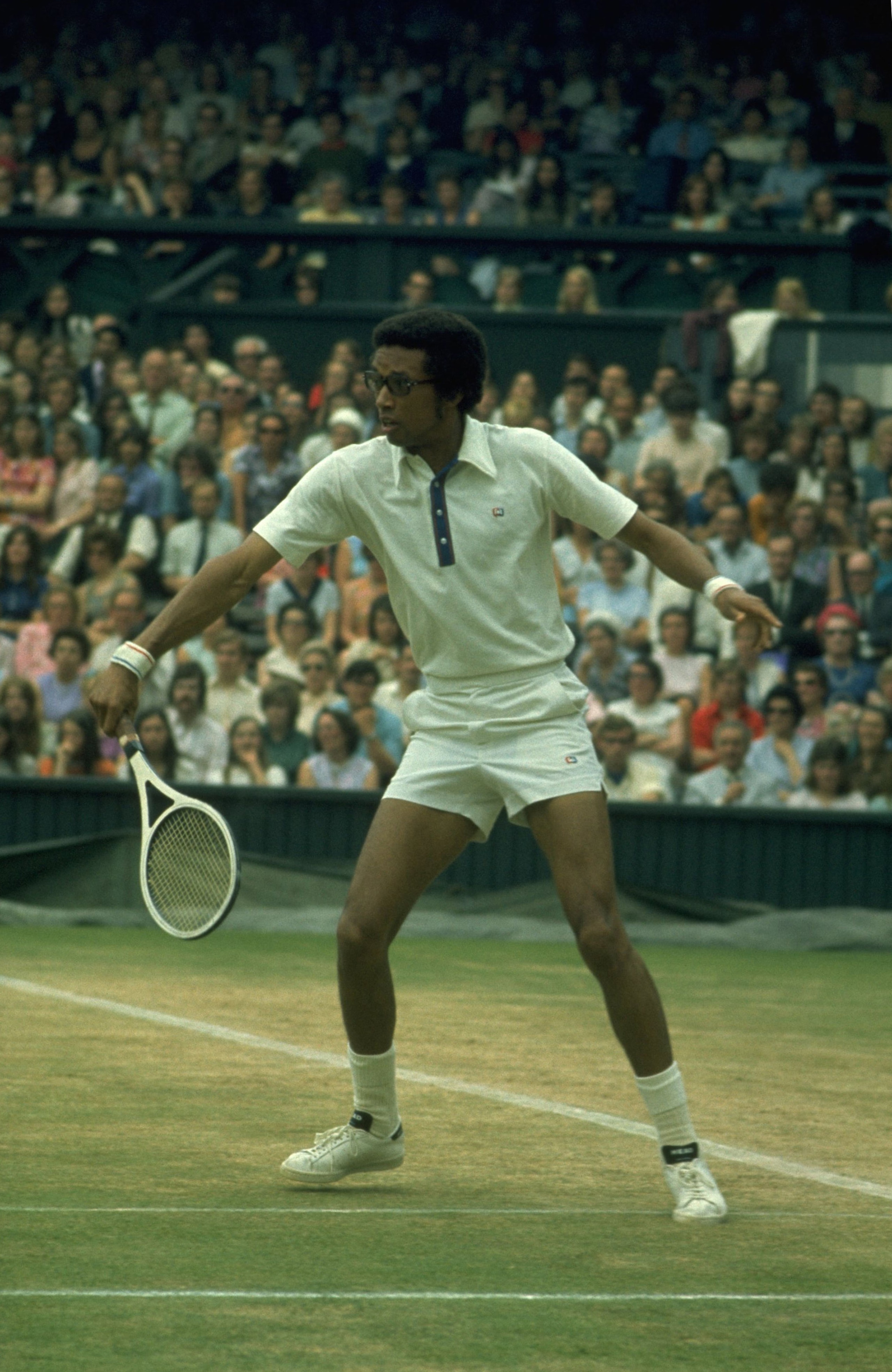 JUN 1975:  ARTHUR ASHE OF THE UNITED STATES HITS A BACKHAND ON THE CENTRE COURT AT WIMBLEDON DURING THE MENS SINGLES.