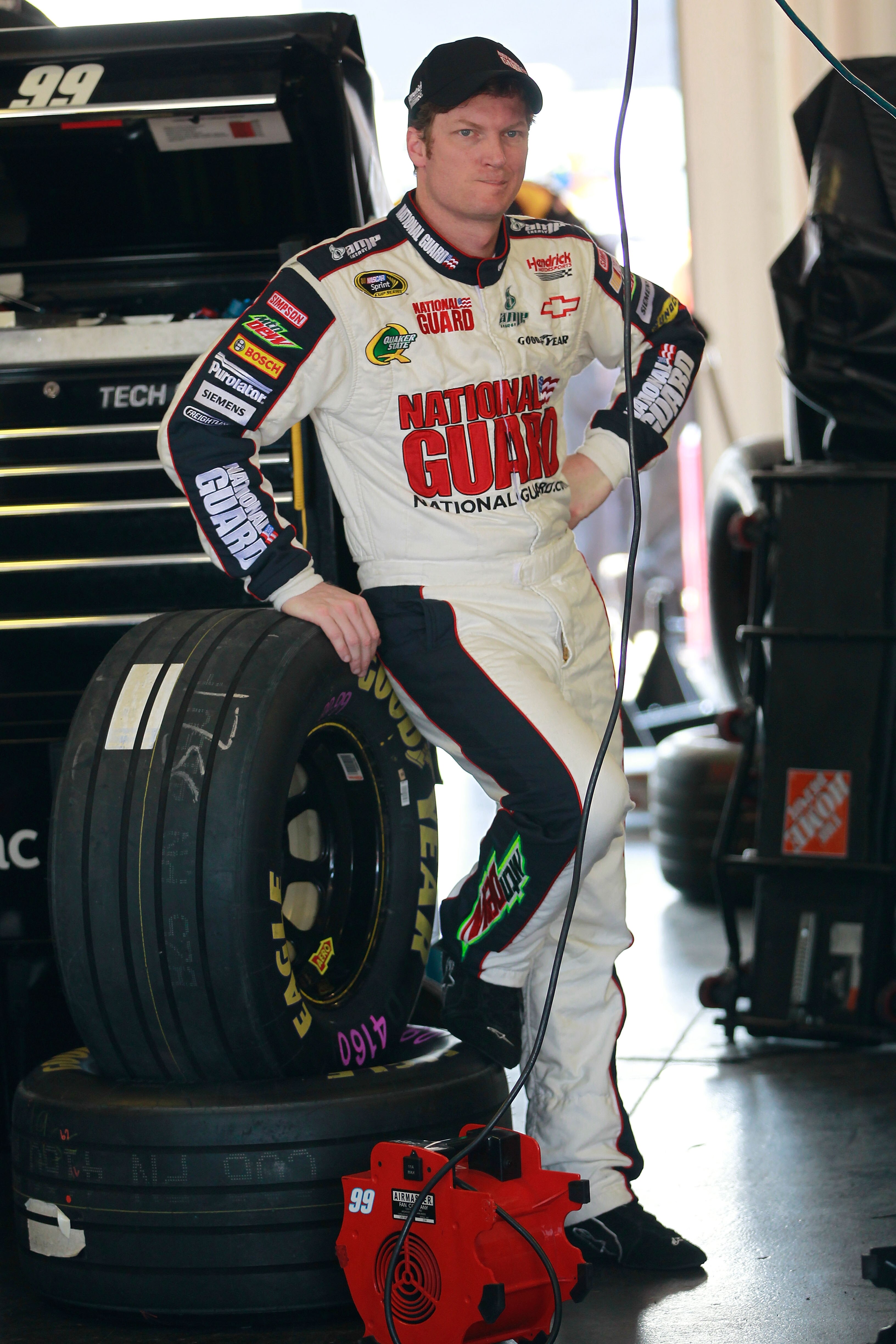 LONG POND, PA - JUNE 10:  Dale Earnhardt Jr., driver of the #88 National Guard/Amp Energy Chevrolet, stands in the garage area during practice for the NASCAR Sprint Cup Series 5-Hour Energy 500 at Pocono Raceway on June 10, 2011 in Long Pond, Pennsylvania