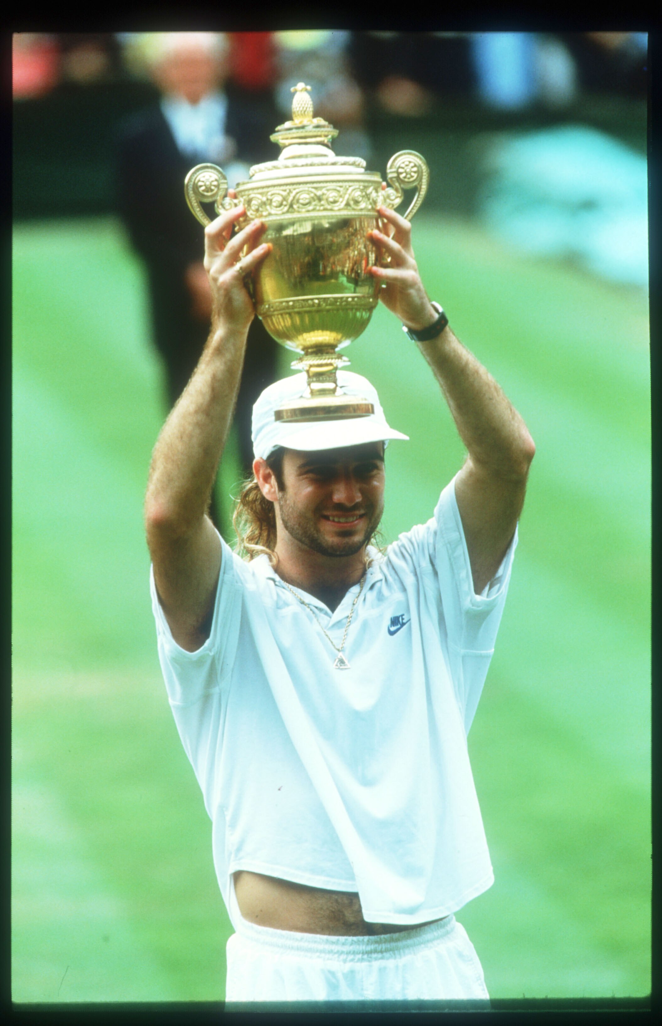 131886 07: Tennis Player Andre Agassi Holds His Trophy After Winning At Wimbledon July 5, 1992 In England. Agassi Won His First Grand Slam Title At Wimbledon, Beating Becker And Mcenroe Along The Way, And Ivanisevic In The Finals.  (Photo By John Russell/