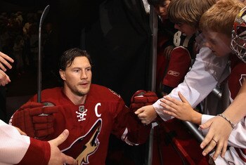 GLENDALE, AZ - APRIL 18:  Shane Doan #19 of the Phoenix Coyotes walks past fans onto the ice for warm ups to Game Three of the Western Conference Quarterfinals against the Detroit Red Wings during the 2011 NHL Stanley Cup Playoffs at Jobing.com Arena on A