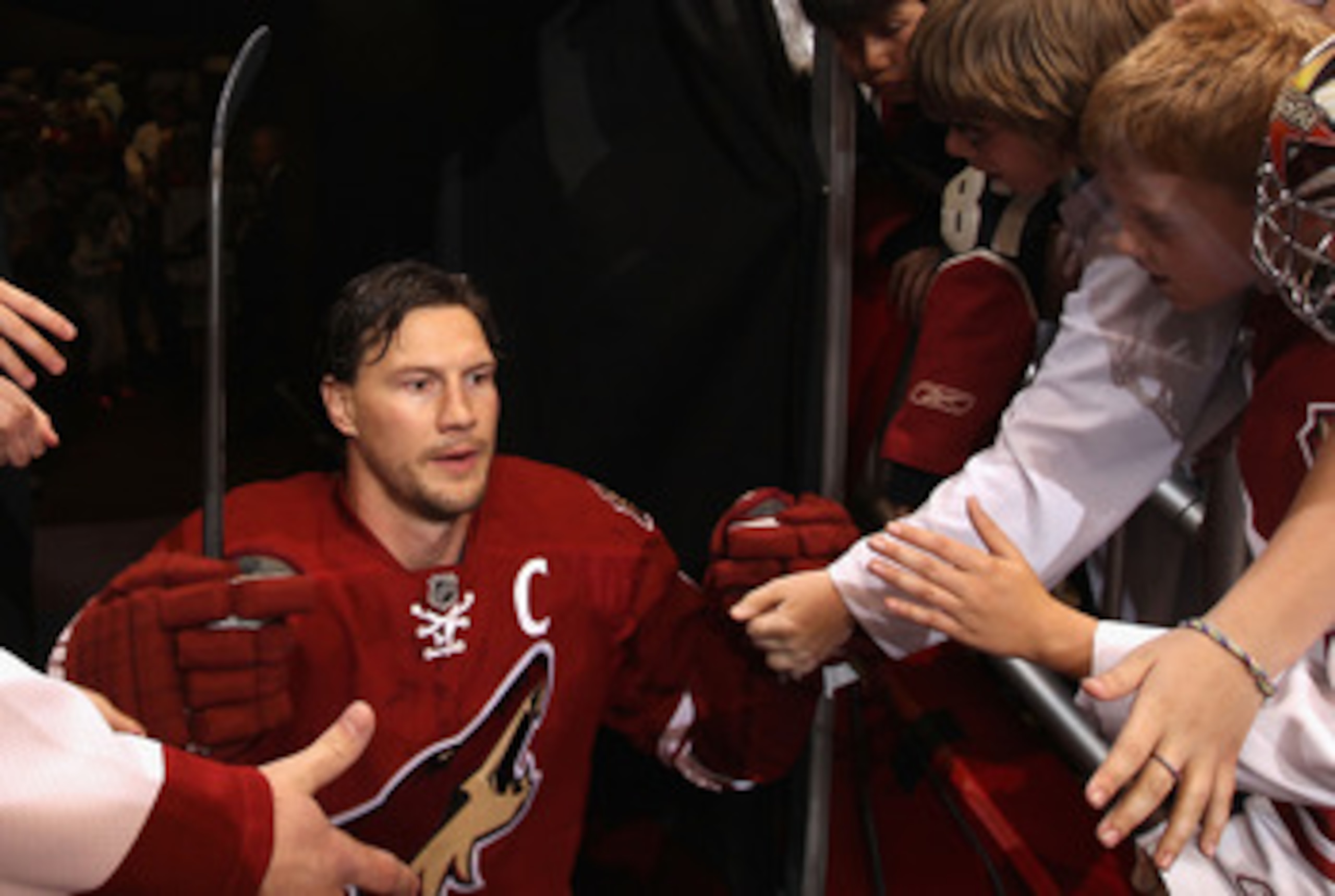 GLENDALE, AZ - APRIL 18:  Shane Doan #19 of the Phoenix Coyotes walks past fans onto the ice for warm ups to Game Three of the Western Conference Quarterfinals against the Detroit Red Wings during the 2011 NHL Stanley Cup Playoffs at Jobing.com Arena on A