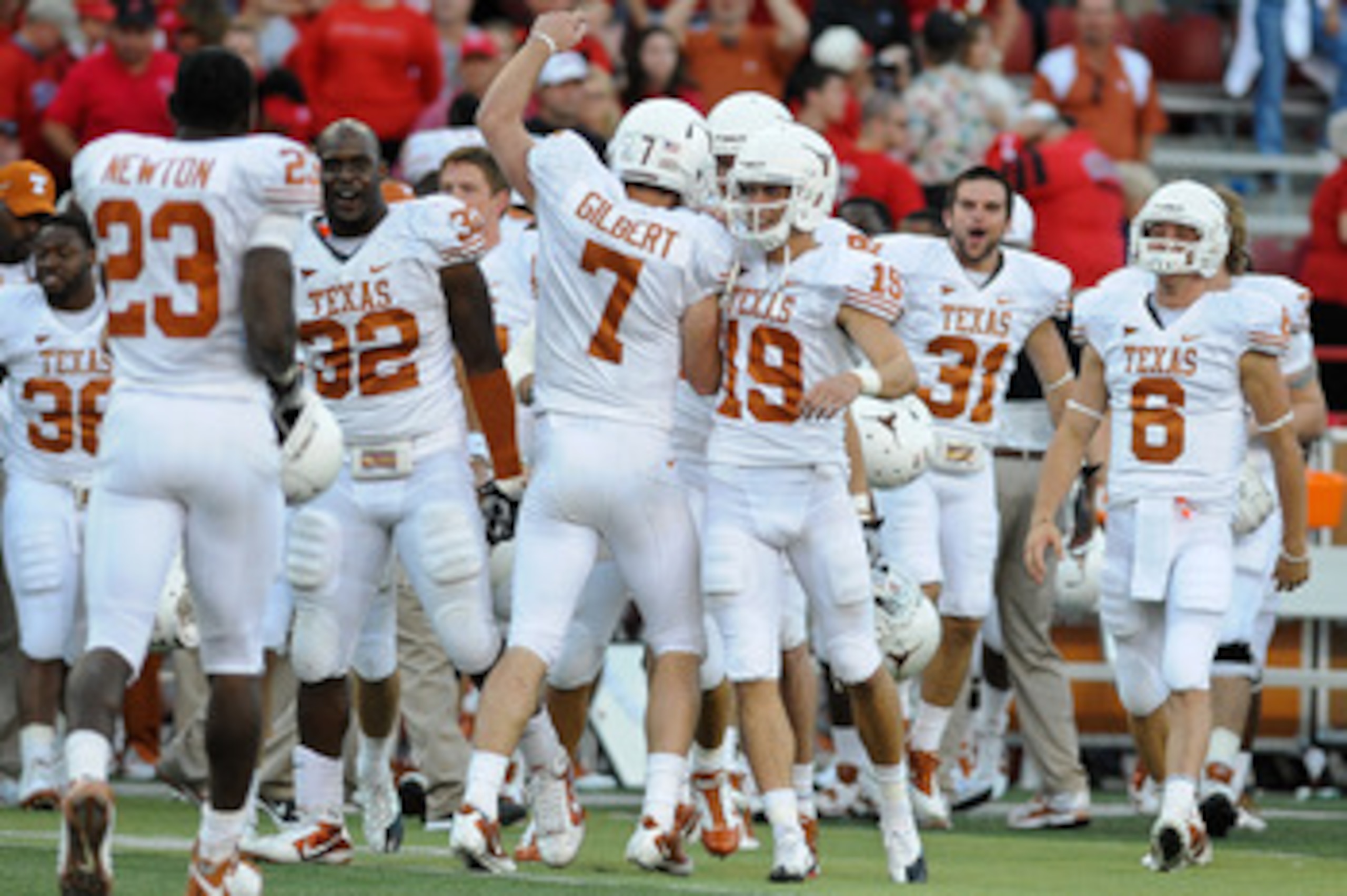 LINCOLN, NE - OCTOBER 16: Quarterback Garrett Gilbert #7 of the Texas Longhorns runs toward his teammates ofter the final of their game against the Nebraska Cornhuskers at Memorial Stadium on October 16, 2010 in Lincoln, Nebraska. Texas Defeated Nebraska LINCOLN, NE - OCTOBER 16: Quarterback Garrett Gilbert #7 of the Texas Longhorns runs toward his teammates ofter the final of their game against the Nebraska Cornhuskers at Memorial Stadium on October 16, 2010 in Lincoln, Nebraska. Texas Defeated Nebraska