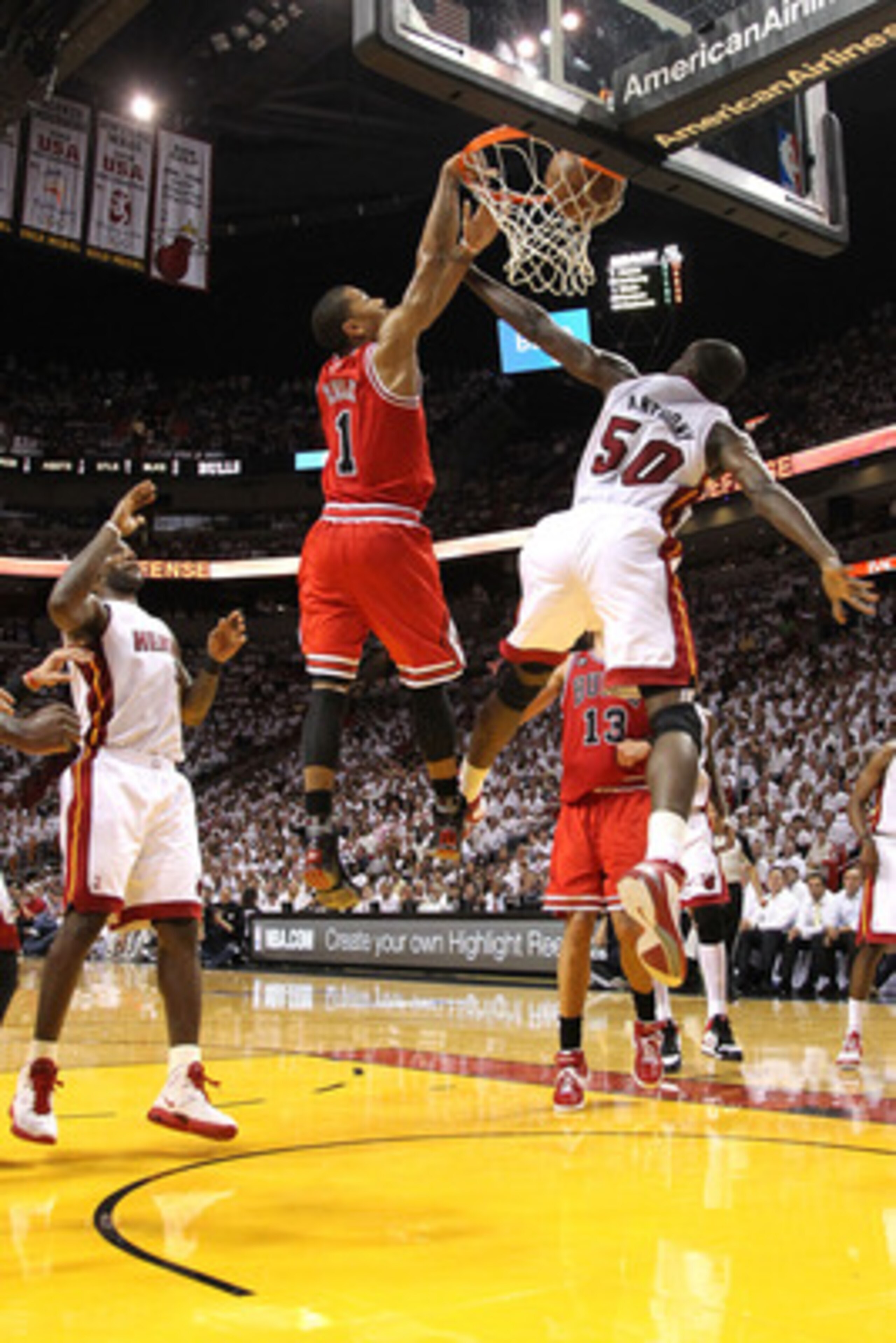 MIAMI, FL - MAY 24:  Derrick Rose #1 of the Chicago Bulls dunks on Joel Anthony #50 of the Miami Heat as LeBron James #6 of the Heat looks on in the first half of Game Four of the Eastern Conference Finals during the 2011 NBA Playoffs on May 24, 2011 at A