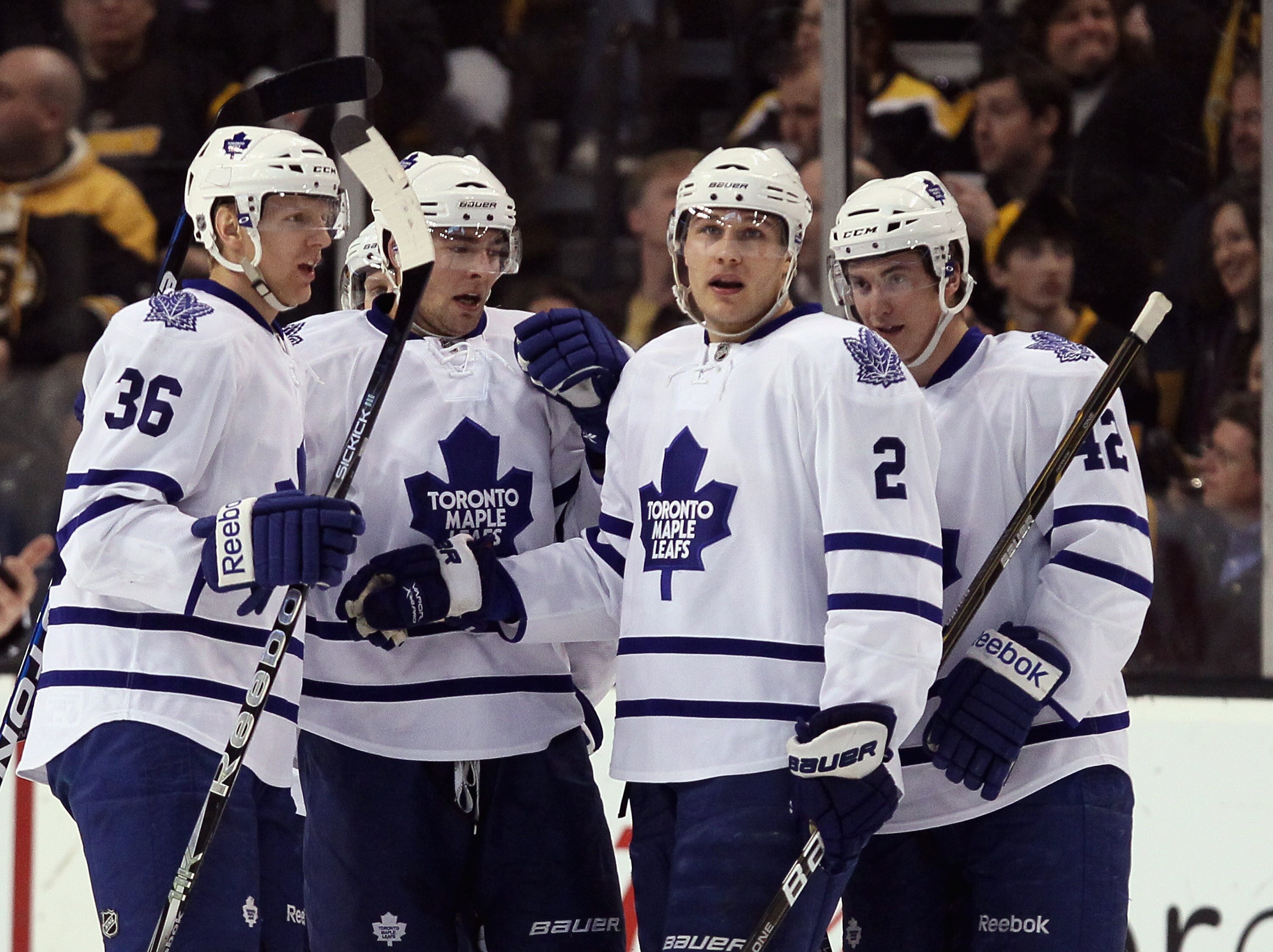 BOSTON, MA - MARCH 31:  Luke Schenn #2 of the Toronto Maple Leafs is congratulated by teammates Carl Gunnarsson #36 and Tyler Bozak #42 after Schenn scored a goal in the first period against the Boston Bruins on March 31, 2011 at the TD Garden in Boston,