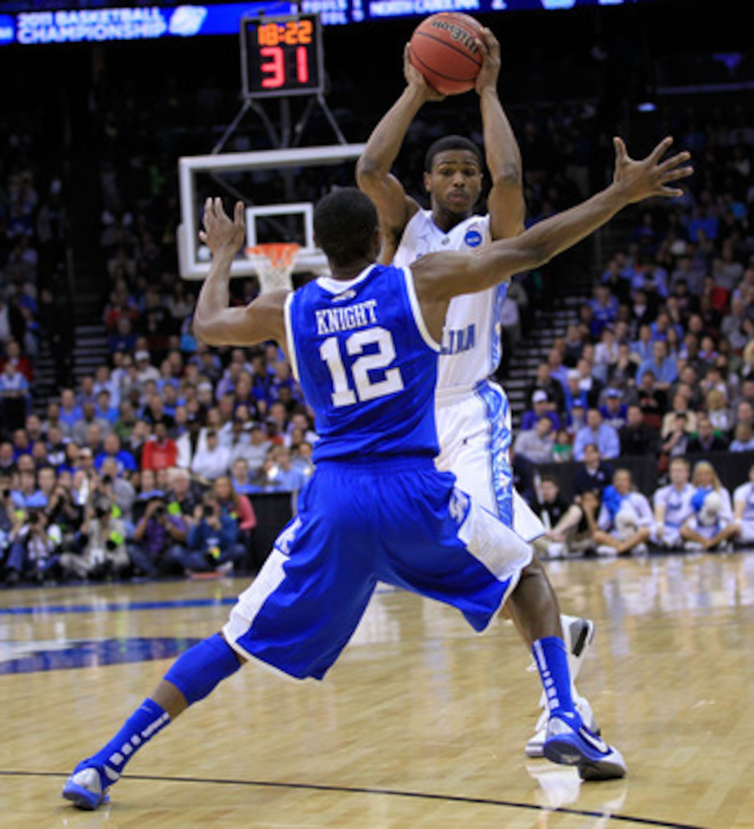 NEWARK, NJ - MARCH 27: Brandon Knight #12 of the Kentucky Wildcats blocks Dexter Strickland #1 of the North Carolina Tar Heels during the east regional final of the 2011 NCAA men's basketball tournament at Prudential Center on March 27, 2011 in Newark, N NEWARK, NJ - MARCH 27: Brandon Knight #12 of the Kentucky Wildcats blocks Dexter Strickland #1 of the North Carolina Tar Heels during the east regional final of the 2011 NCAA men's basketball tournament at Prudential Center on March 27, 2011 in Newark, N