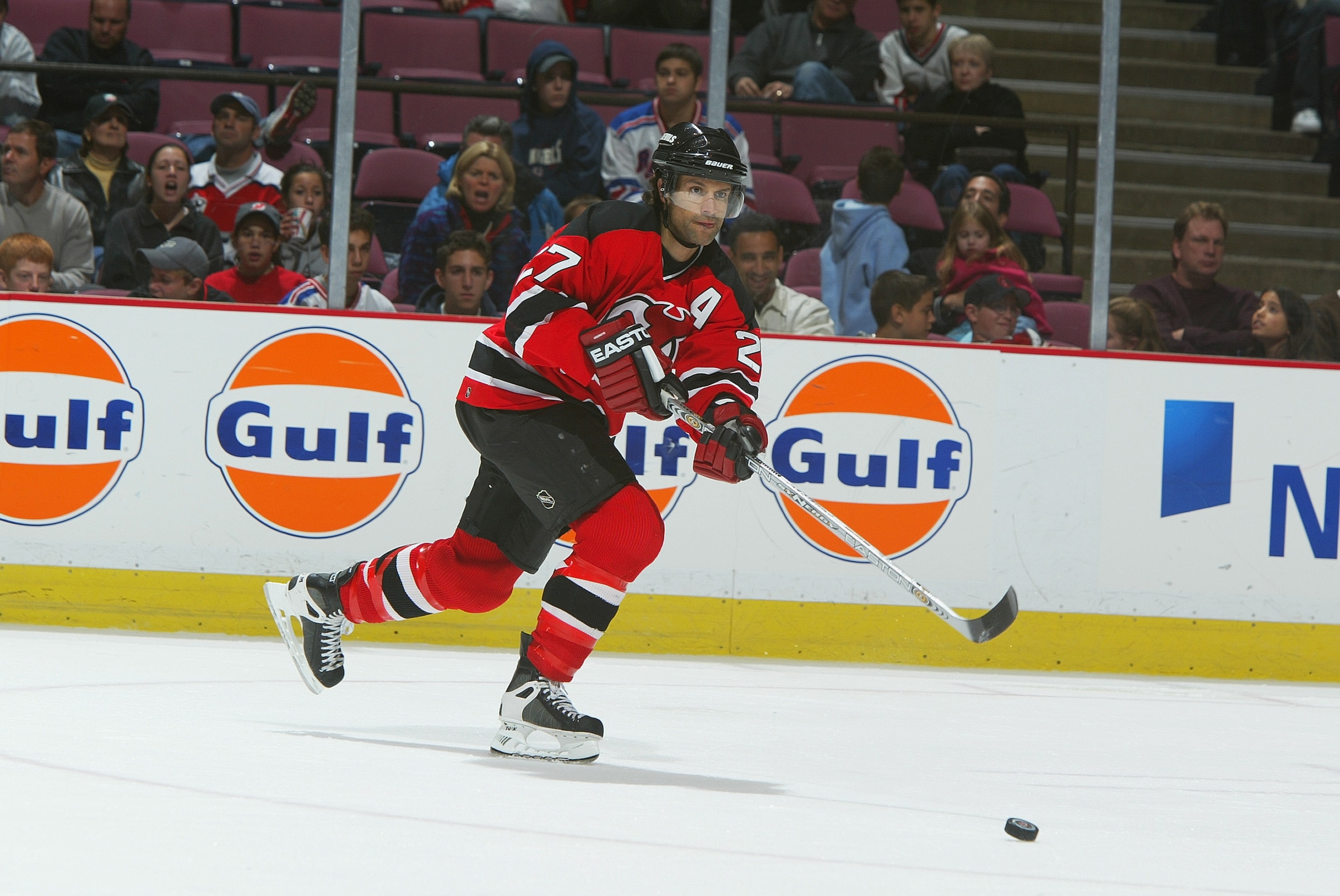 EAST RUTHERFORD, NJ - OCTOBER 3:  Defenseman Scott Niedermayer #27 of the New Jersey Devils passes the puck against the New York Rangers during the preseason NHL game on October 3, 2003 at Continental Airlines Arena in East Rutherford, New Jersey. The Dev