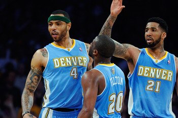 LOS ANGELES, CA - APRIL 03:  Kenyon Martin #4 of the Denver Nuggets celebrates with teammates Raymond Felton #20 and Wilson Chandler #21 after scoring a basket against the Los Angeles Lakers during the NBA basketball game at Staples Center on April 3, 201