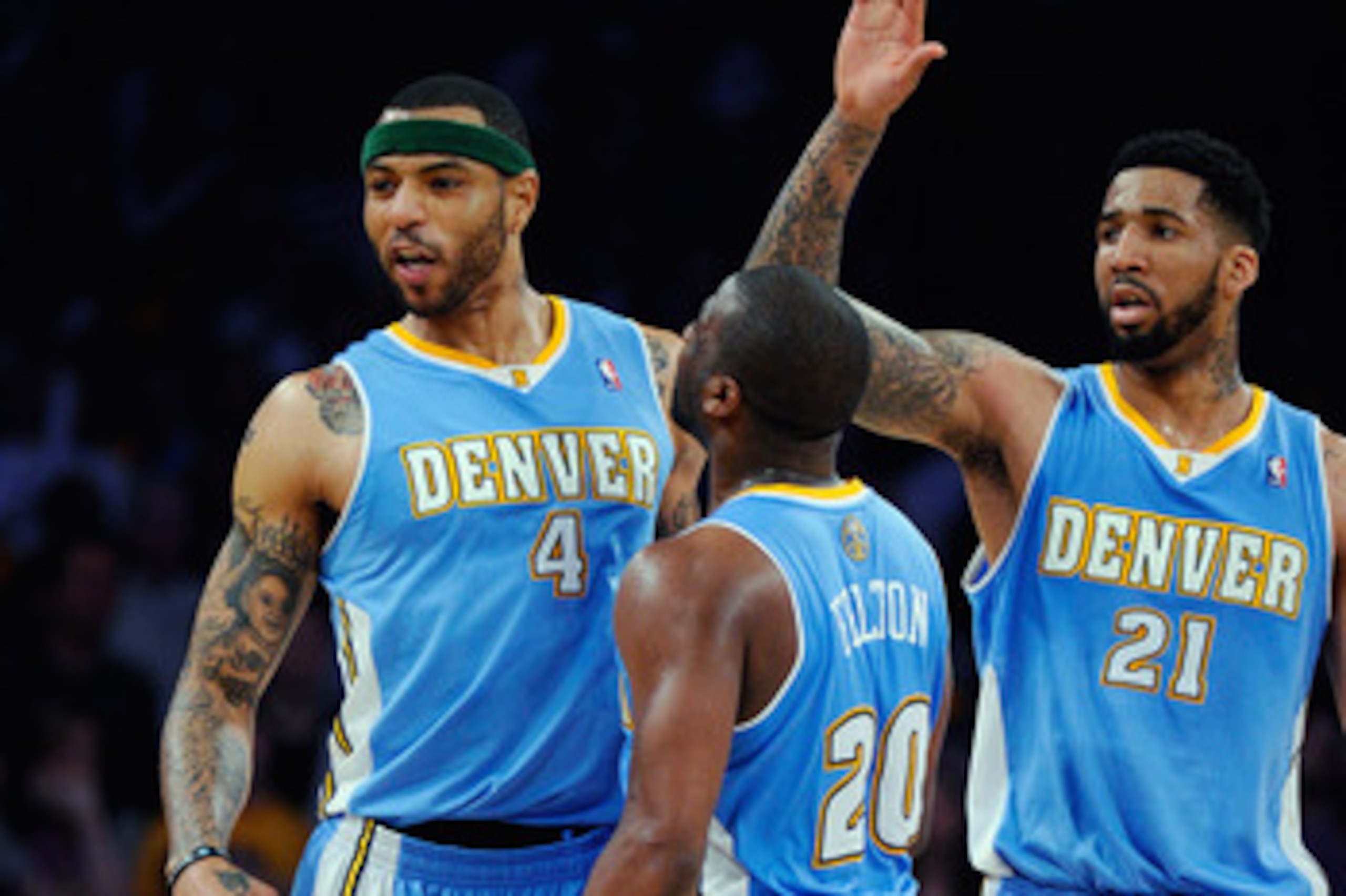LOS ANGELES, CA - APRIL 03:  Kenyon Martin #4 of the Denver Nuggets celebrates with teammates Raymond Felton #20 and Wilson Chandler #21 after scoring a basket against the Los Angeles Lakers during the NBA basketball game at Staples Center on April 3, 201