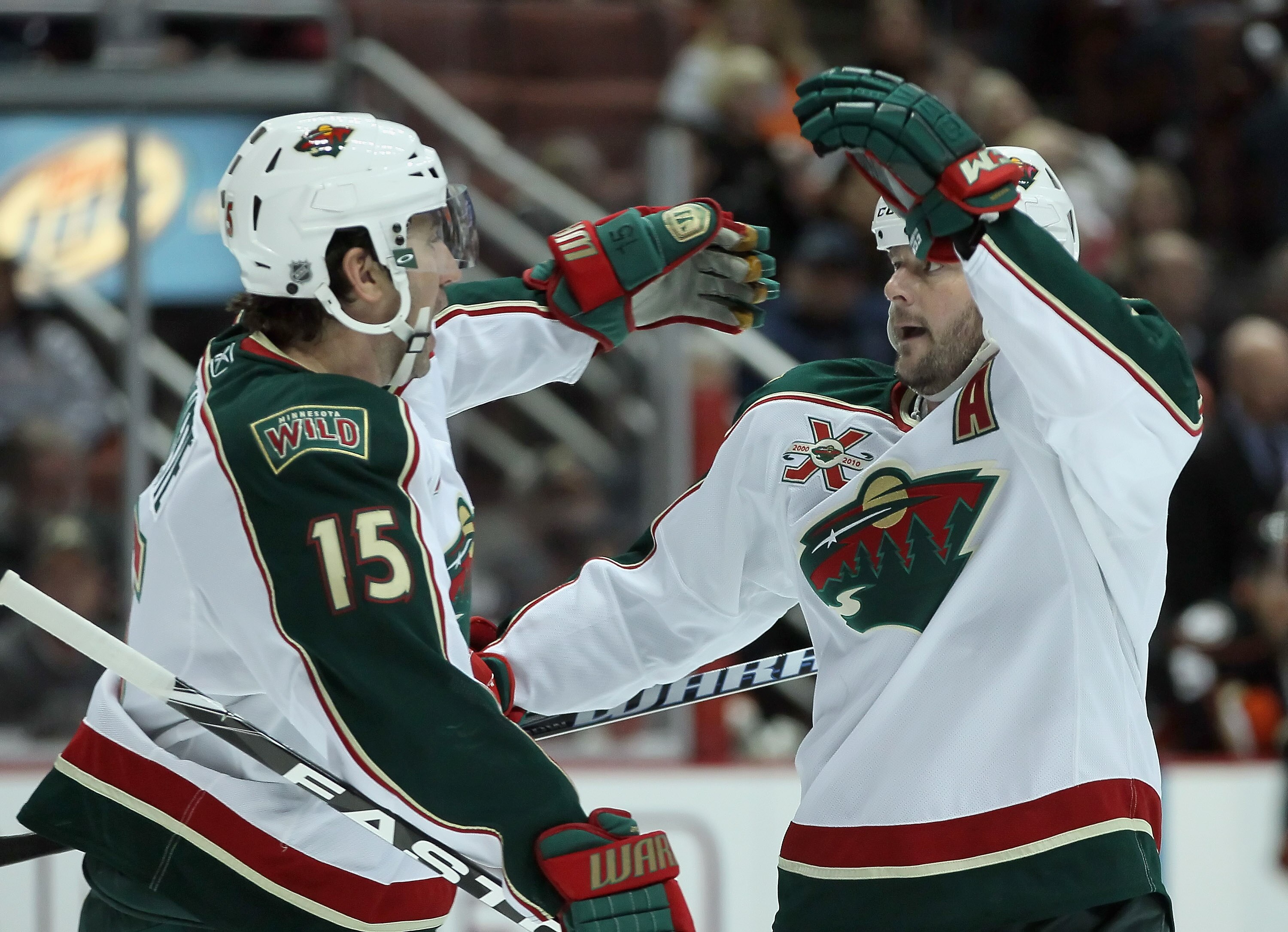 ANAHEIM, CA - FEBRUARY 25:  Andrew Brunett #15 and John Madden #11 of the Minnesota Wild celebrate Madden's first period goal against the Anaheim Ducks at Honda Center on February 25, 2011 in Anaheim, California.  (Photo by Jeff Gross/Getty Images)