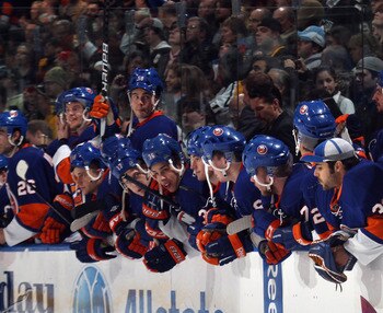 UNIONDALE, NY - APRIL 08:  The New York Islanders watch the shoot out against the Pittsburgh Penguins with their helmets on backwards for good luck at the Nassau Coliseum on April 8, 2011 in Uniondale, New York.  (Photo by Bruce Bennett/Getty Images)