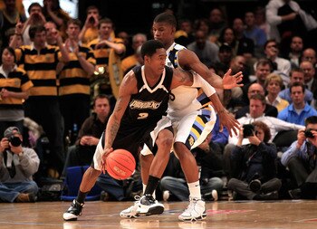 NEW YORK, NY - MARCH 08: Marshon Brooks #2 of the Providence Friars dribbles the ball against Jimmy Butler #33 of the Marquette Golden Eagles during the first round of the 2011 Big East Men's Basketball Tournament presented by American Eagle Outfitters at