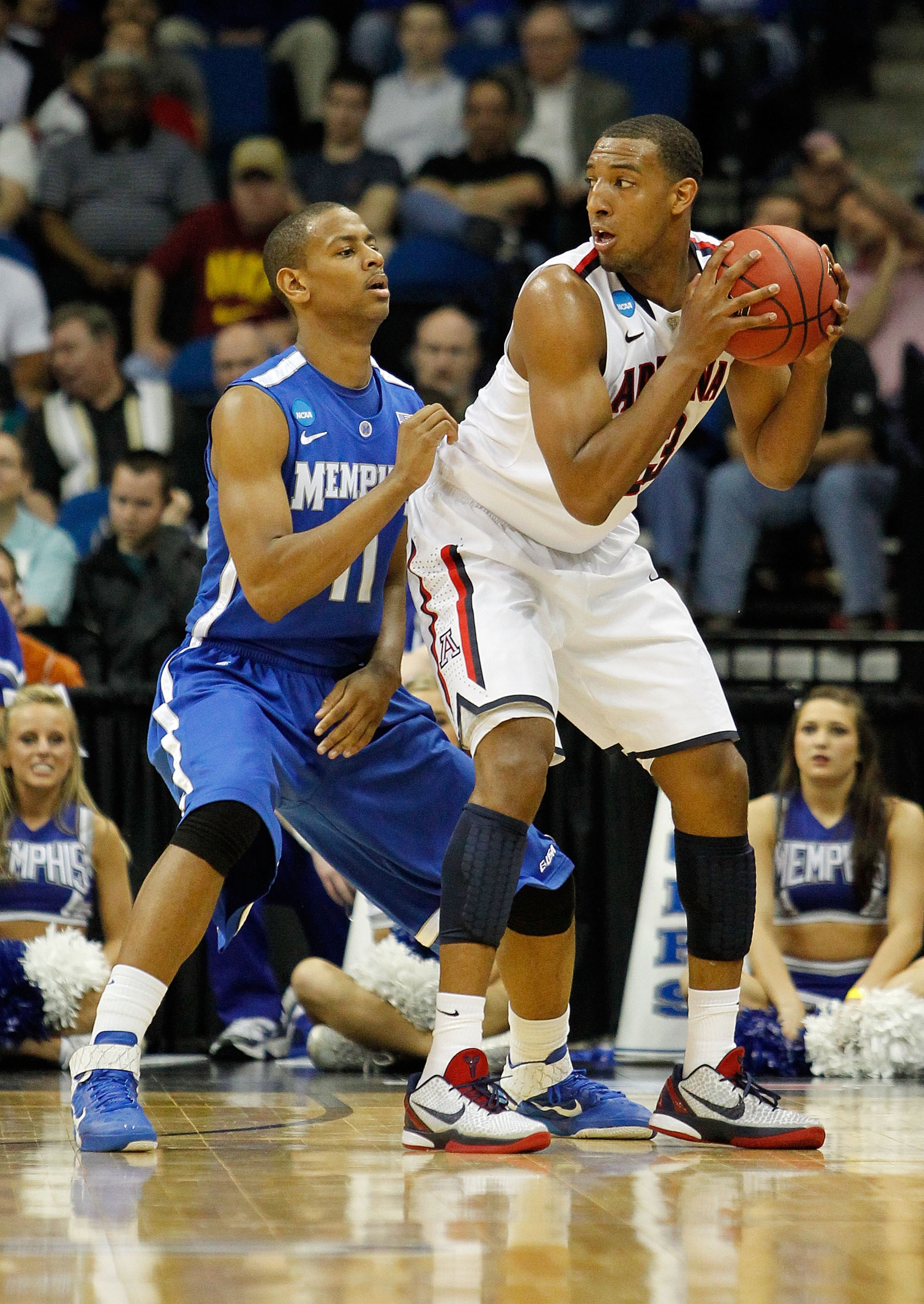 TULSA, OK - MARCH 18:  Derrick Williams #23 of the Arizona Wildcats looks to move the ball as Wesley Witherspoon #11 of the Memphis Tigers defends during the second round game of the 2011 NCAA men's basketball tournament at BOK Center on March 18, 2011 in