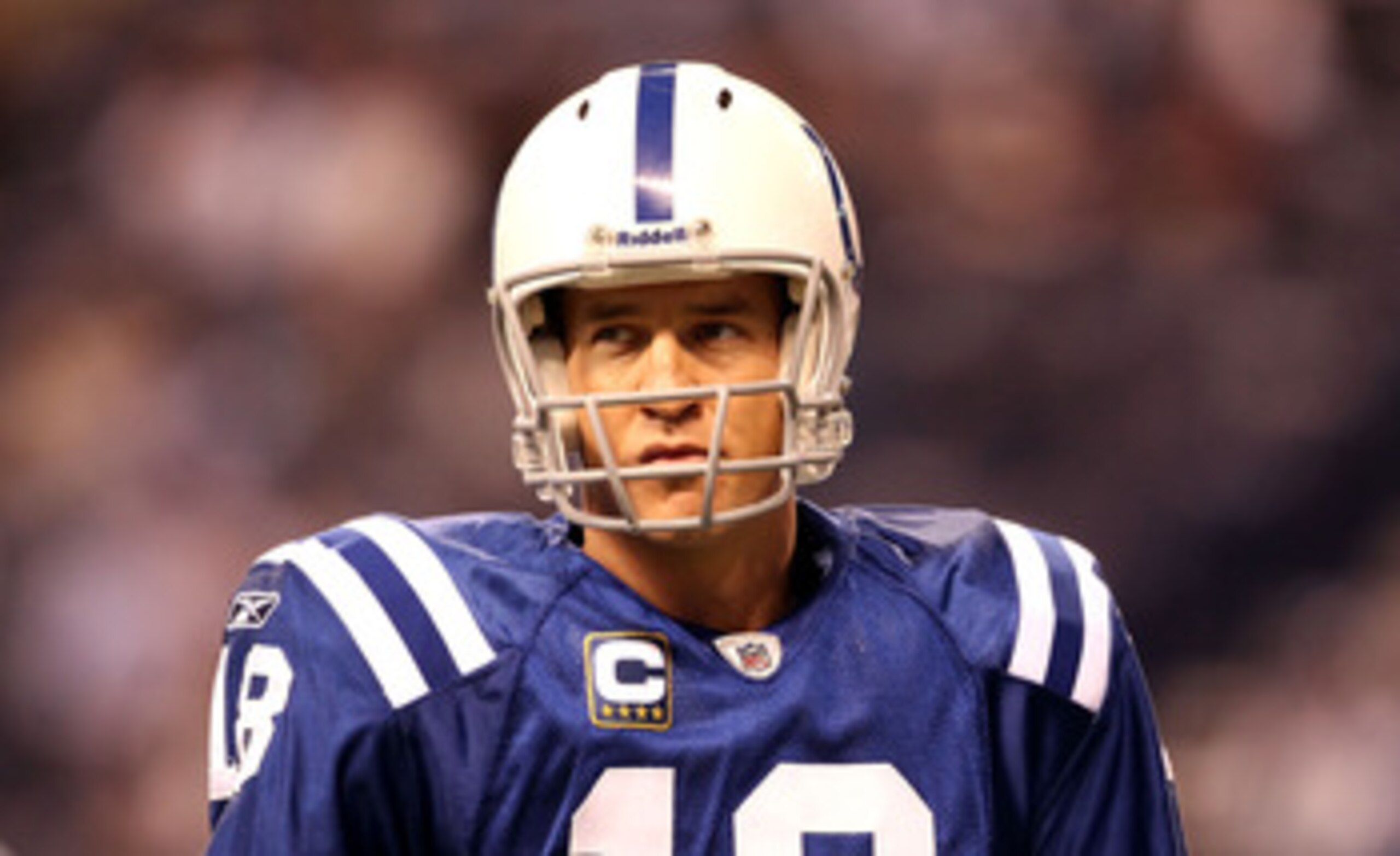 INDIANAPOLIS, IN - JANUARY 08:  Quarterback Peyton Manning #18 of the Indianapolis Colts looks on during warm ups against the New York Jets during their 2011 AFC wild card playoff game at Lucas Oil Stadium on January 8, 2011 in Indianapolis, Indiana.  (Ph