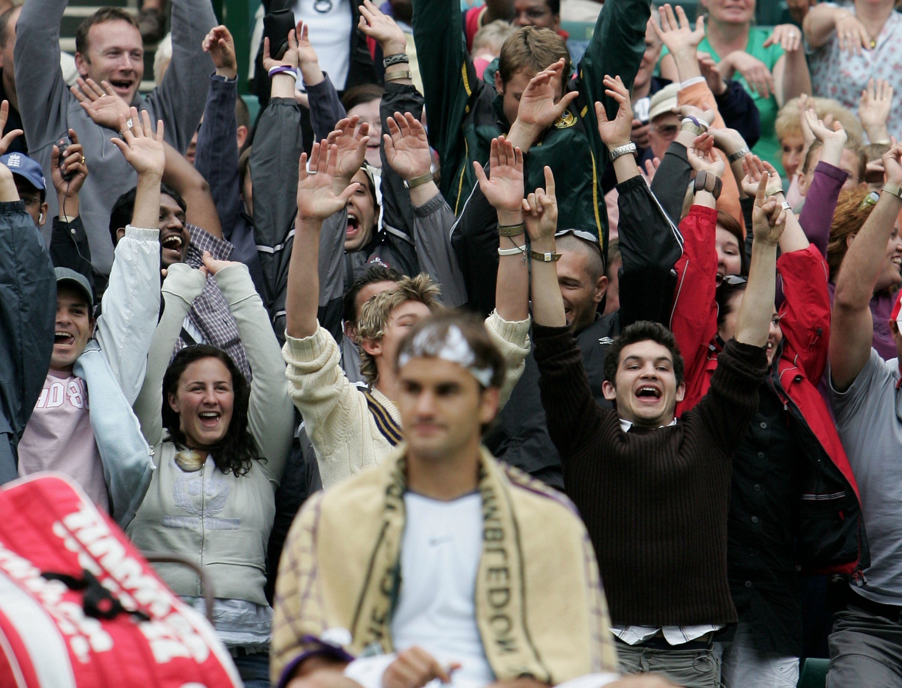 LONDON - JUNE 25:  The crowd do a Mexican Wave during the match between Roger Federer of Switzerland and Nicolas Kiefer of Germany during the sixth day of the Wimbledon Lawn Tennis Championship on June 25, 2005 at the All England Lawn Tennis and Croquet C
