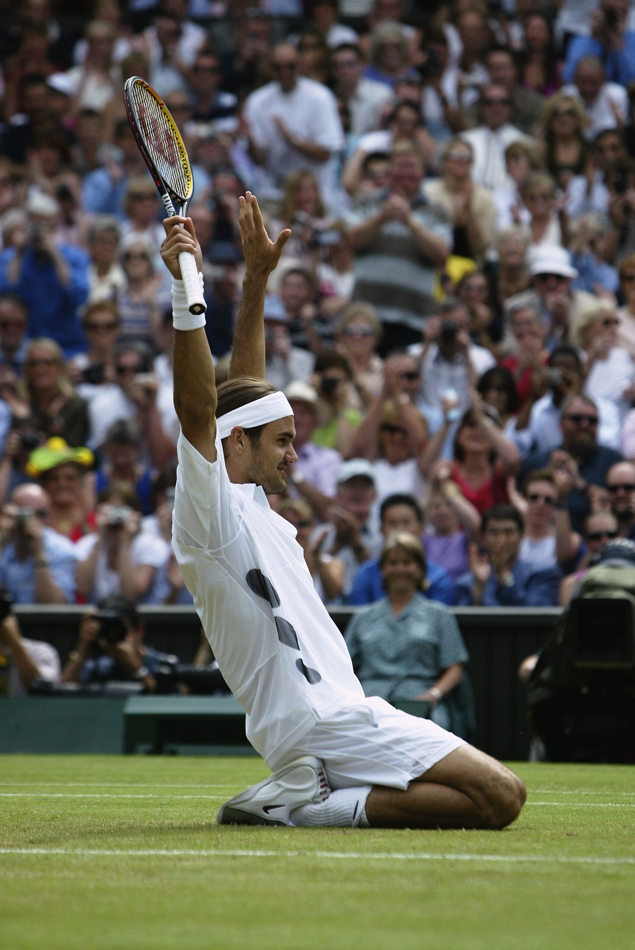 LONDON - JULY 6:  Roger Federer of Switzerland celebrates after his victory over Mark Philippoussis of Australia in the Men's Singles Final during the final day of the Wimbledon Lawn Tennis Championships held on July 6, 2003 at the All England Lawn Tennis