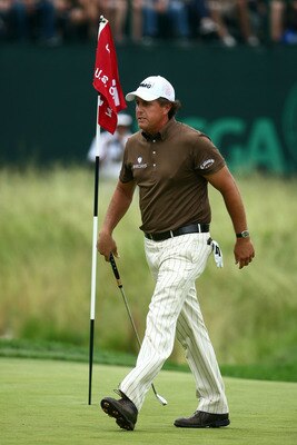 FARMINGDALE, NY - JUNE 22:  Phil Mickelson walks across the 18th green during the continuation of the final round of the 109th U.S. Open on the Black Course at Bethpage State Park on June 22, 2009 in Farmingdale, New York.  (Photo by Chris McGrath/Getty I