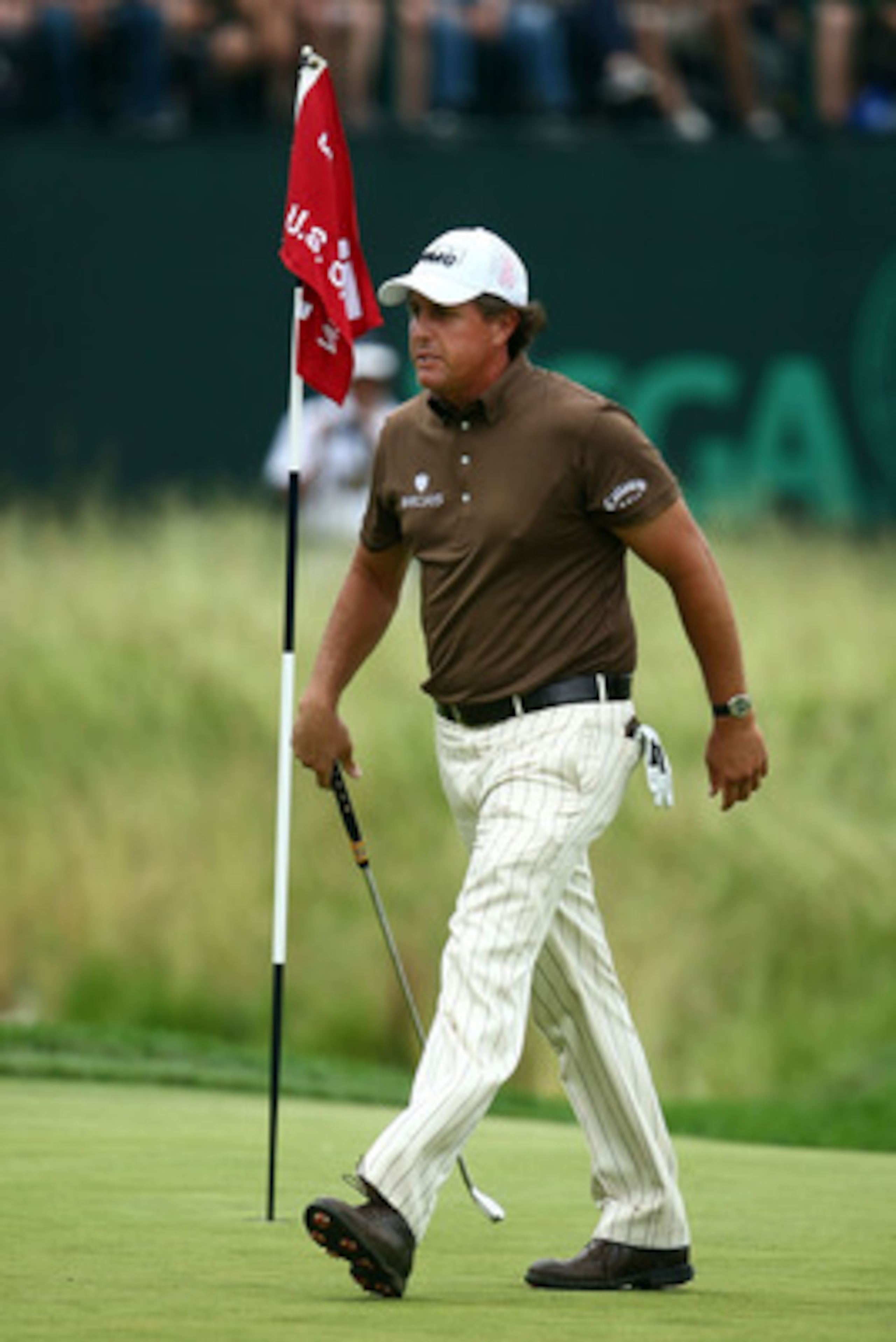 FARMINGDALE, NY - JUNE 22:  Phil Mickelson walks across the 18th green during the continuation of the final round of the 109th U.S. Open on the Black Course at Bethpage State Park on June 22, 2009 in Farmingdale, New York.  (Photo by Chris McGrath/Getty I