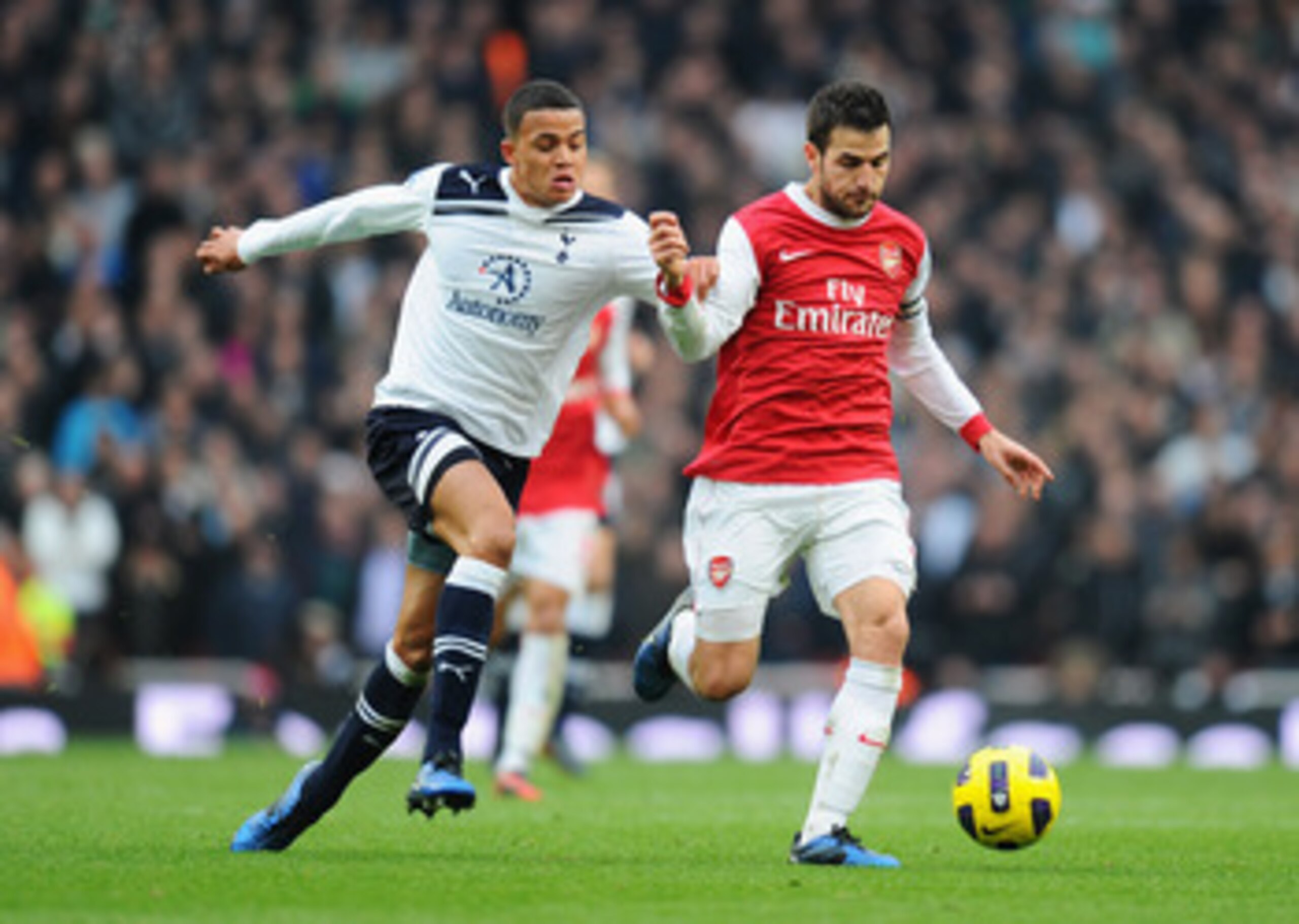 LONDON, ENGLAND - NOVEMBER 20:  Jermaine Jenas of Tottenham challenges Cesc Fabregas of Arsenal during the Barclays Premier League match between Arsenal and Tottenham Hotspur at the Emirates Stadium on November 20, 2010 in London, England.  (Photo by Mike