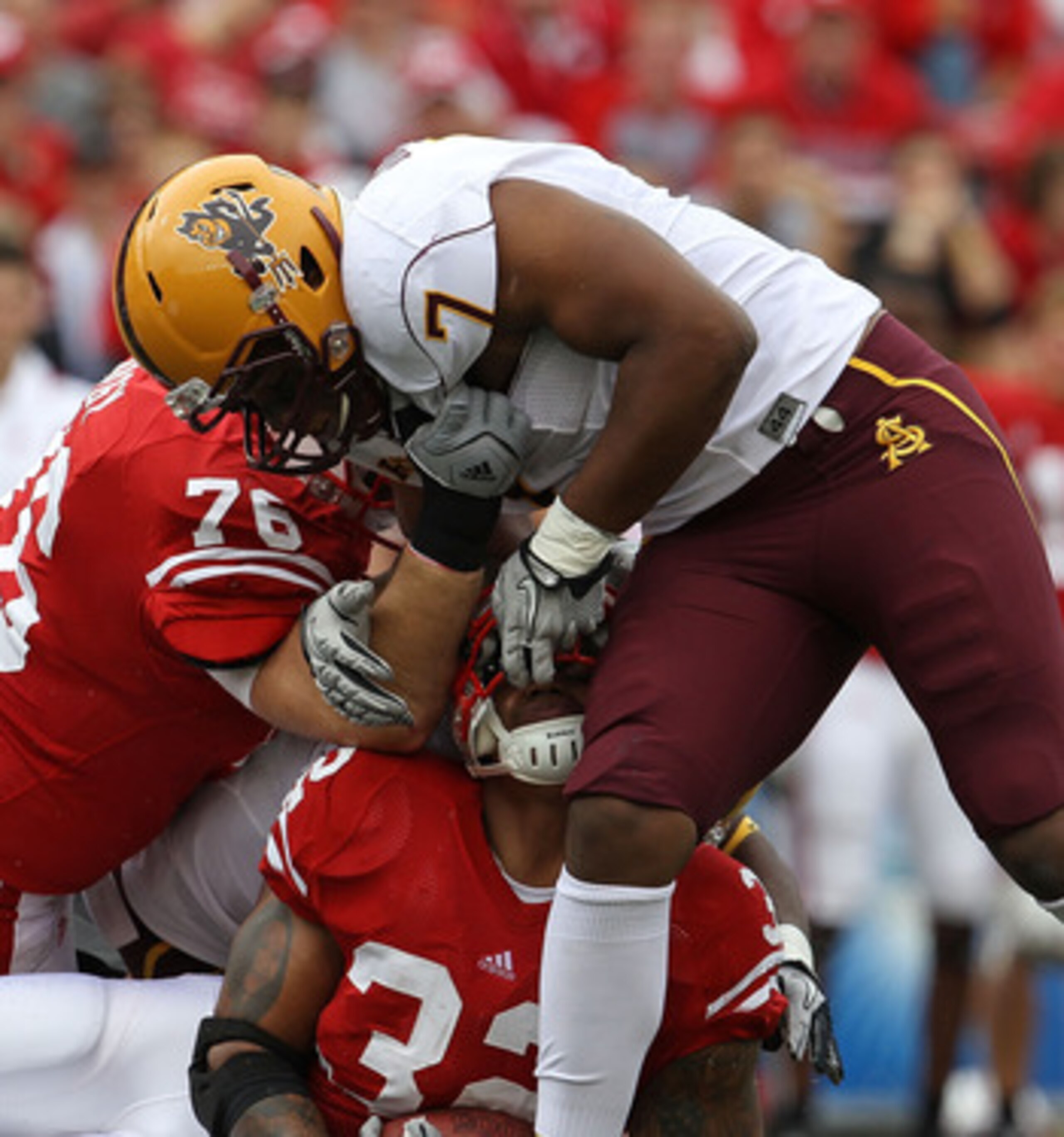 MADISON, WI - SEPTEMBER 18: John Clay #32 of the Wisconsin Badgers is tackled by the fask mask by Vontaze Burfict #7 of the Arizona State Sun Devils at Camp Randall Stadium on September 18, 2010 in Madison, Wisconsin. (Photo by Jonathan Daniel/Getty Image