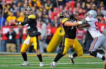 IOWA CITY, IA - NOVEMBER 20:  Quarterback Ricky Stanzi #12 of the University of Iowa Hawkeyes throws under pressure from defensive lineman Solomon Thomas #98 of the Ohio State Buckeyes as offensive lineman Riley Reiff #77 defends during the first half of 