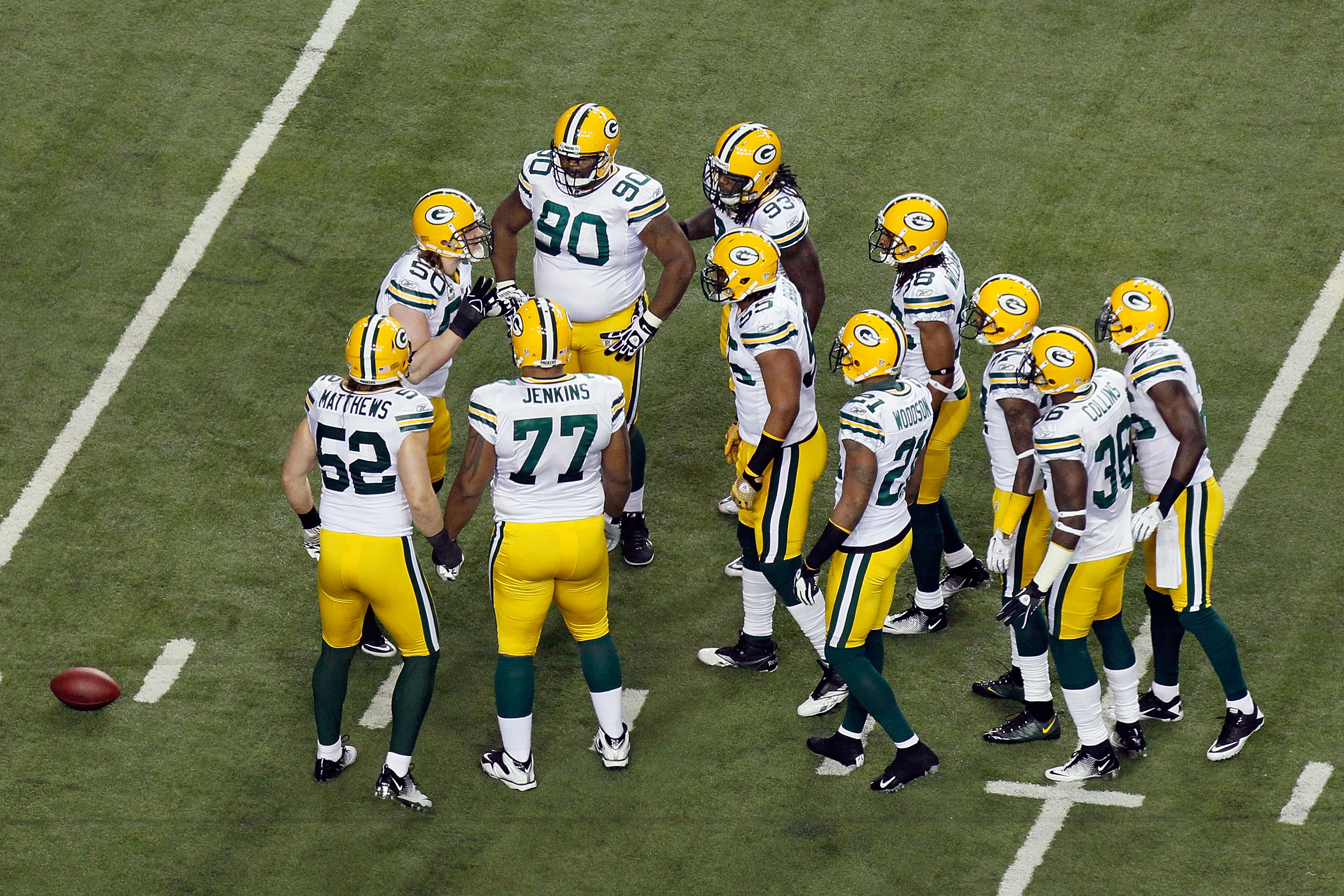 ATLANTA, GA - JANUARY 15:  A.J. Hawk #50 of the Green Bay Packers calls a play in the defensive huddle to teammates including Clay Matthews #52 and B.J. Raji #90 against the Atlanta Falcons during their 2011 NFC divisional playoff game at Georgia Dome on