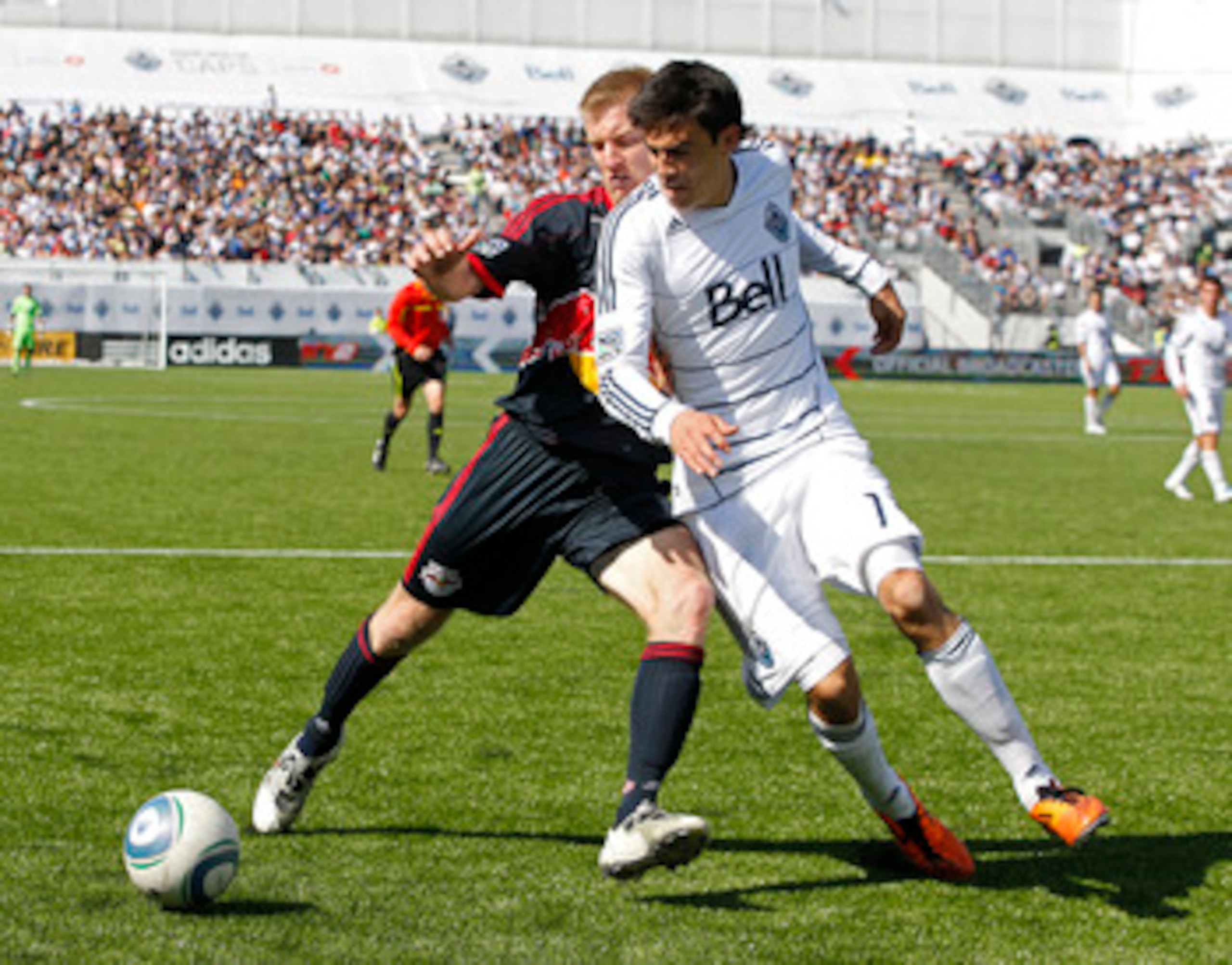 VANCOUVER, CANADA - MAY 28:  Omar Salgado #17 of the Vancouver Whitecaps FC and Tim Ream #5 of the New York Red Bulls battle for the ball during their MLS match  May 28, 2011 in Vancouver, British Columbia, Canada.  Vancouver and New York tied 1-1. (Photo