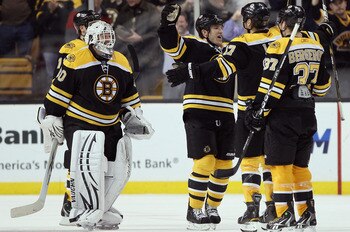 BOSTON, MA - MARCH 24:  Tim Thomas #30, Andrew Ference #21,Milan Lucic #17 and Patrice Bergeron #37 of the Boston Bruins celebrate the win over the Montreal Canadiens on March 24, 2011 at the TD Garden in Boston, Massachusetts.  The Boston Bruins defeated