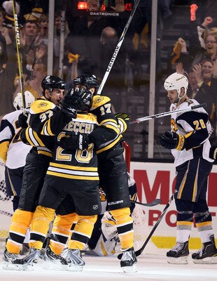 BOSTON - APRIL 19:  Patrice Bergeron #37 of the Boston Bruins is congratulated by teammates Mark Recchi #28 and Milan Lucic #17 after Bergeron scored the game winner in the third period as Paul Gaustad #28 of the Buffalo Sabres looks on in Game Three of t