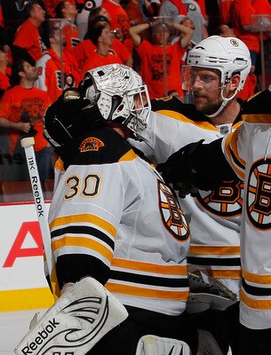 PHILADELPHIA, PA - MAY 02:  Goalie Tim Thomas #30 of the Boston Bruins is congratulated by teammates after a 3-2 overtime win over the Philadelphia Flyers in Game Two of the Eastern Conference Semifinals during the 2011 NHL Stanley Cup Playoffs at Wells F