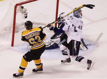 BOSTON, MA - MAY 23:  Brad Marchand #63 of the Boston Bruins scores a second period goal past the defense of Martin St. Louis #26 and Mike Smith #41 of the Tampa Bay Lightning in Game Five of the Eastern Conference Finals during the 2011 NHL Stanley Cup P