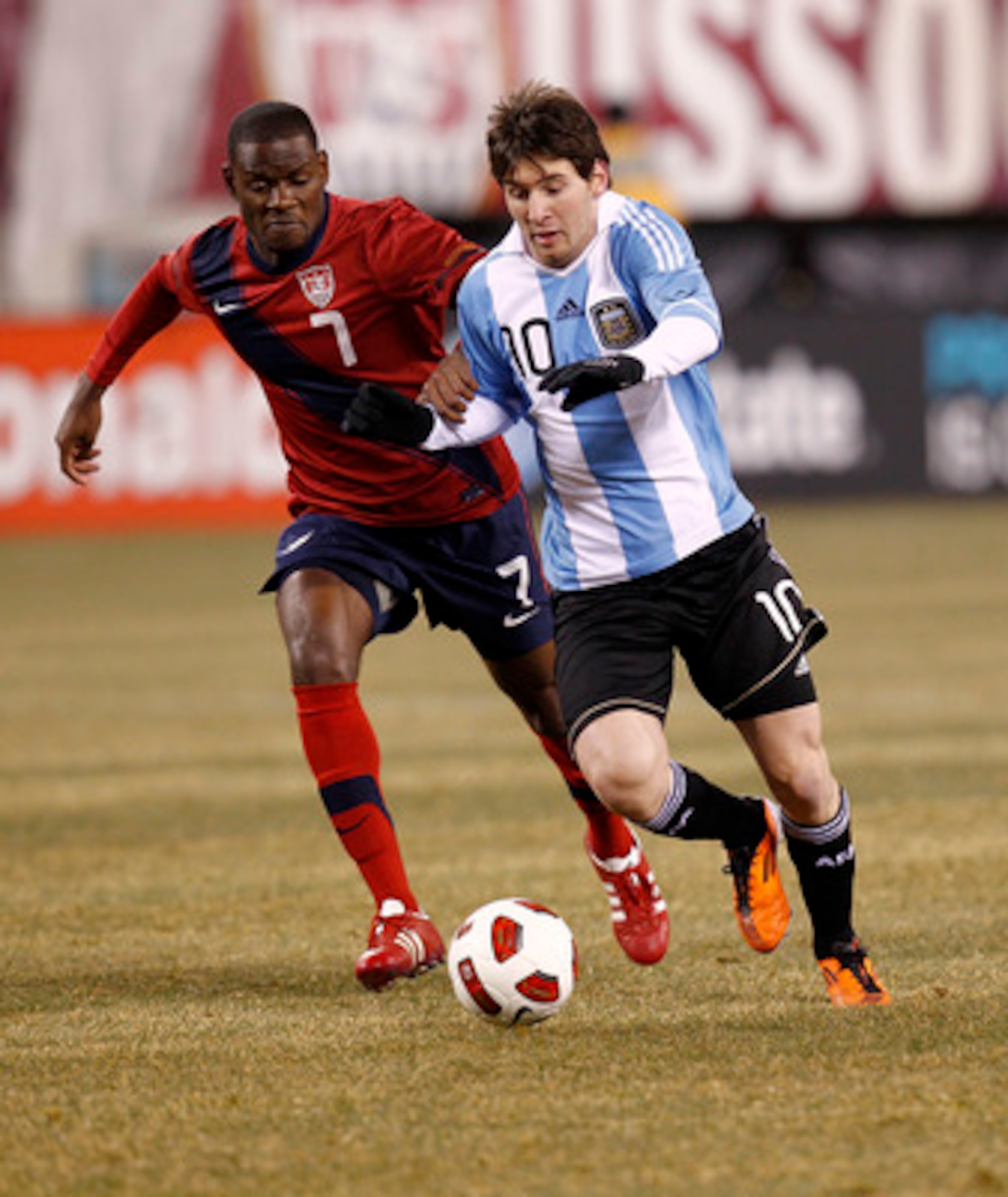 EAST RUTHERFORD, NJ - MARCH 26:  Lionel Messi #10 of Argentina runs with Maurice Edu #7 of the United States during the first half of a friendly match  at New Meadowlands Stadium on March 26, 2011 in East Rutherford, New Jersey.  (Photo by Jeff Zelevansky