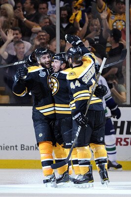 BOSTON, MA - JUNE 08:  Brad Marchand #63 of the Boston Bruins celebrates with his teammates Patrice Bergeron #37 and Dennis Seidenberg #44 after scoring a goal in the second period against Roberto Luongo #1 of the Vancouver Canucks during Game Four of the
