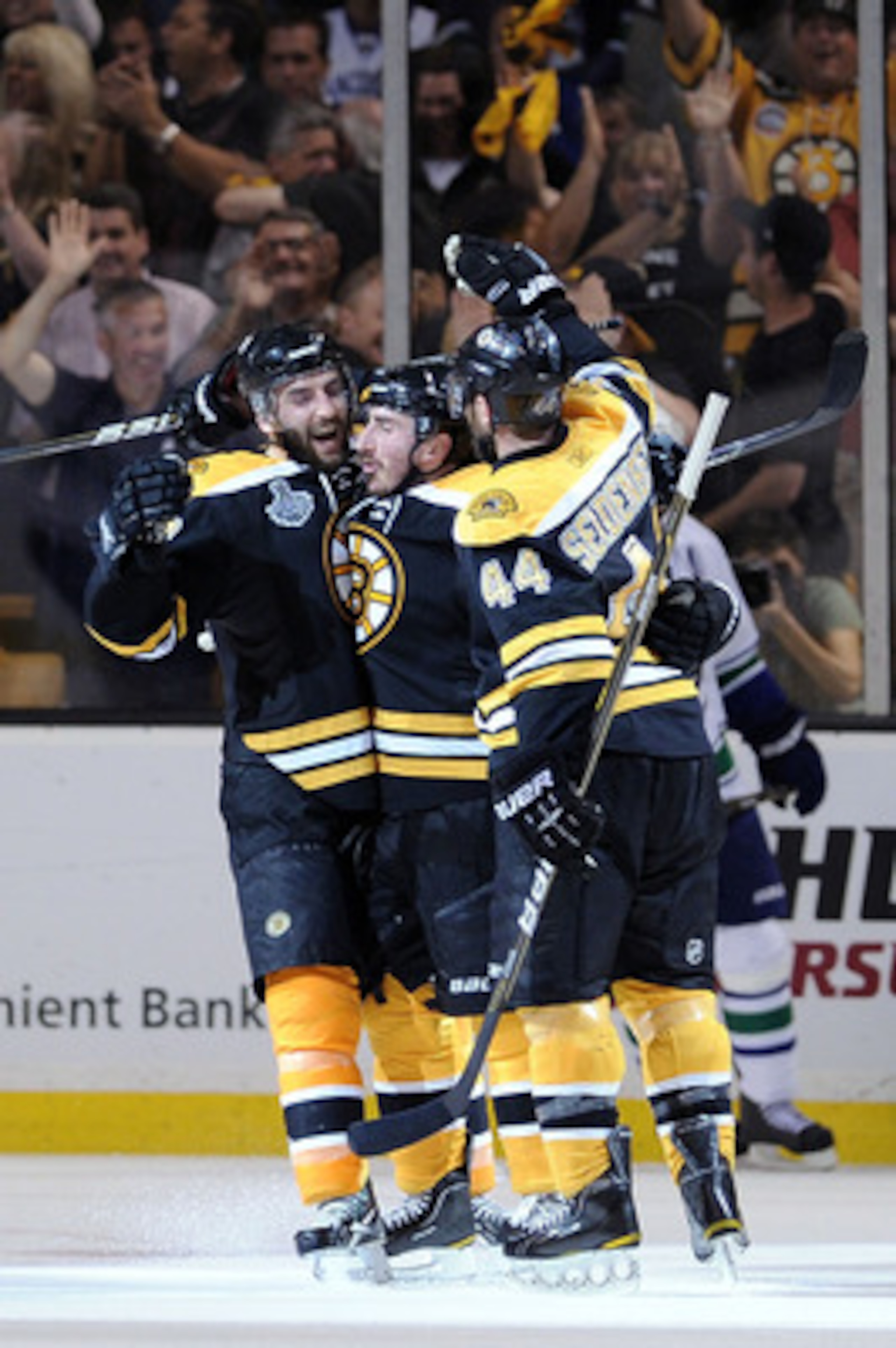BOSTON, MA - JUNE 08:  Brad Marchand #63 of the Boston Bruins celebrates with his teammates Patrice Bergeron #37 and Dennis Seidenberg #44 after scoring a goal in the second period against Roberto Luongo #1 of the Vancouver Canucks during Game Four of the