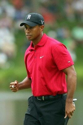 BETHESDA, MD - JULY 05:  Tiger Woods reacts to his shot during the final round of the AT&T National hosted by Tiger Woods at Congressional Country Club on July 5, 2009 in Bethesda, Maryland.  (Photo by Hunter Martin/Getty Images)