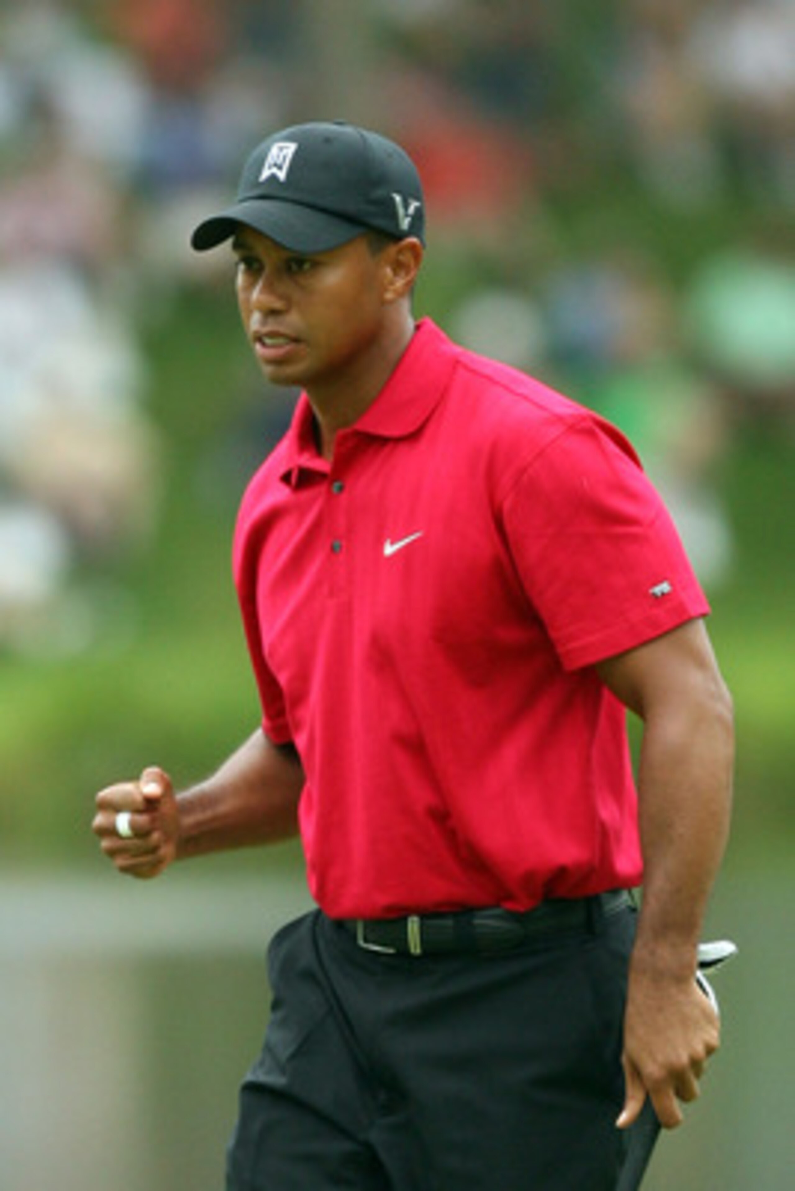 BETHESDA, MD - JULY 05:  Tiger Woods reacts to his shot during the final round of the AT&T National hosted by Tiger Woods at Congressional Country Club on July 5, 2009 in Bethesda, Maryland.  (Photo by Hunter Martin/Getty Images)