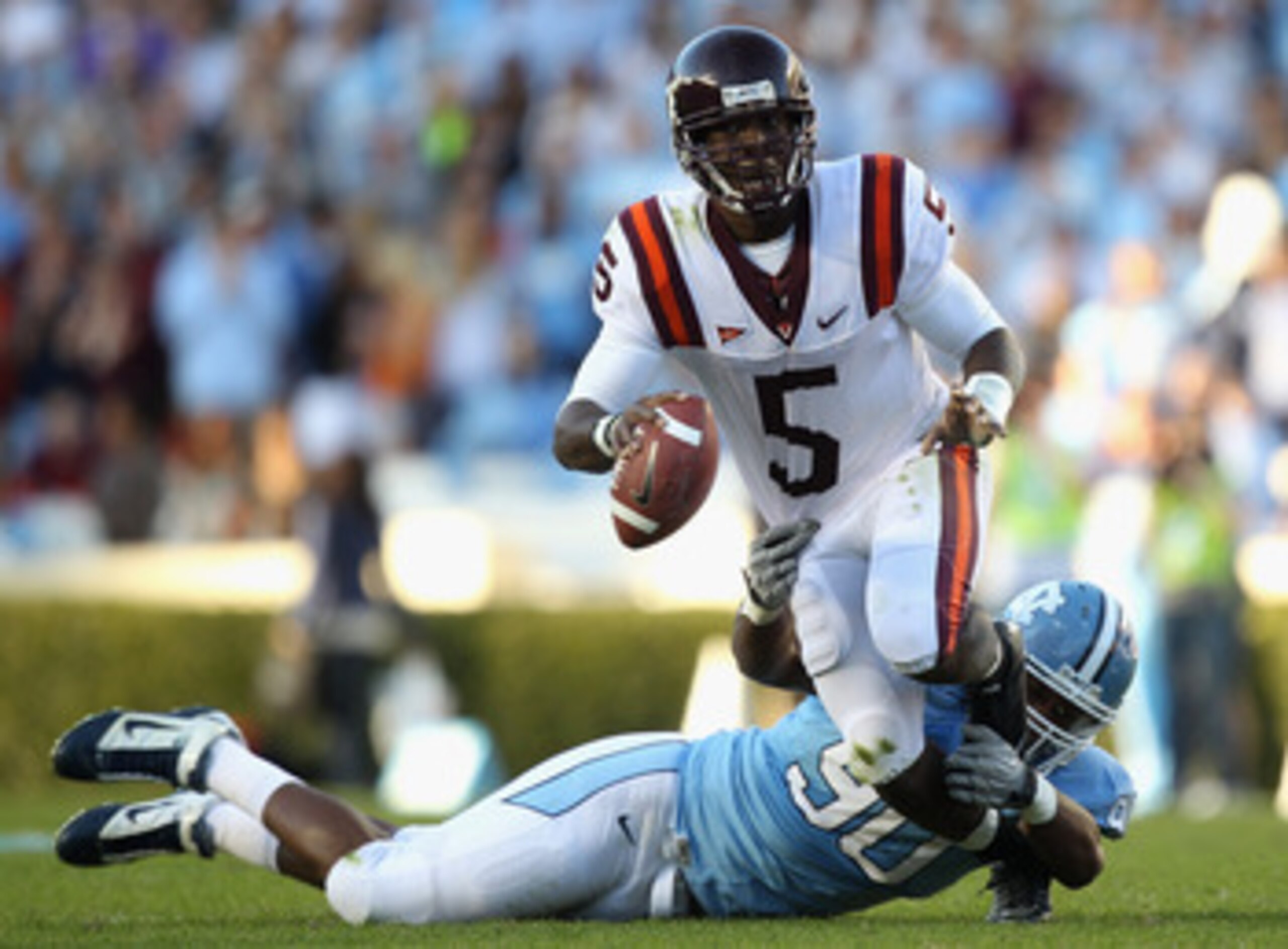 CHAPEL HILL, NC - NOVEMBER 13:  Tyrod Taylor #5 of the Virginia Tech Hokies tries to get away from Quinton Coples #90 of the North Carolina Tar Heels during their game at Kenan Stadium on November 13, 2010 in Chapel Hill, North Carolina.  (Photo by Street
