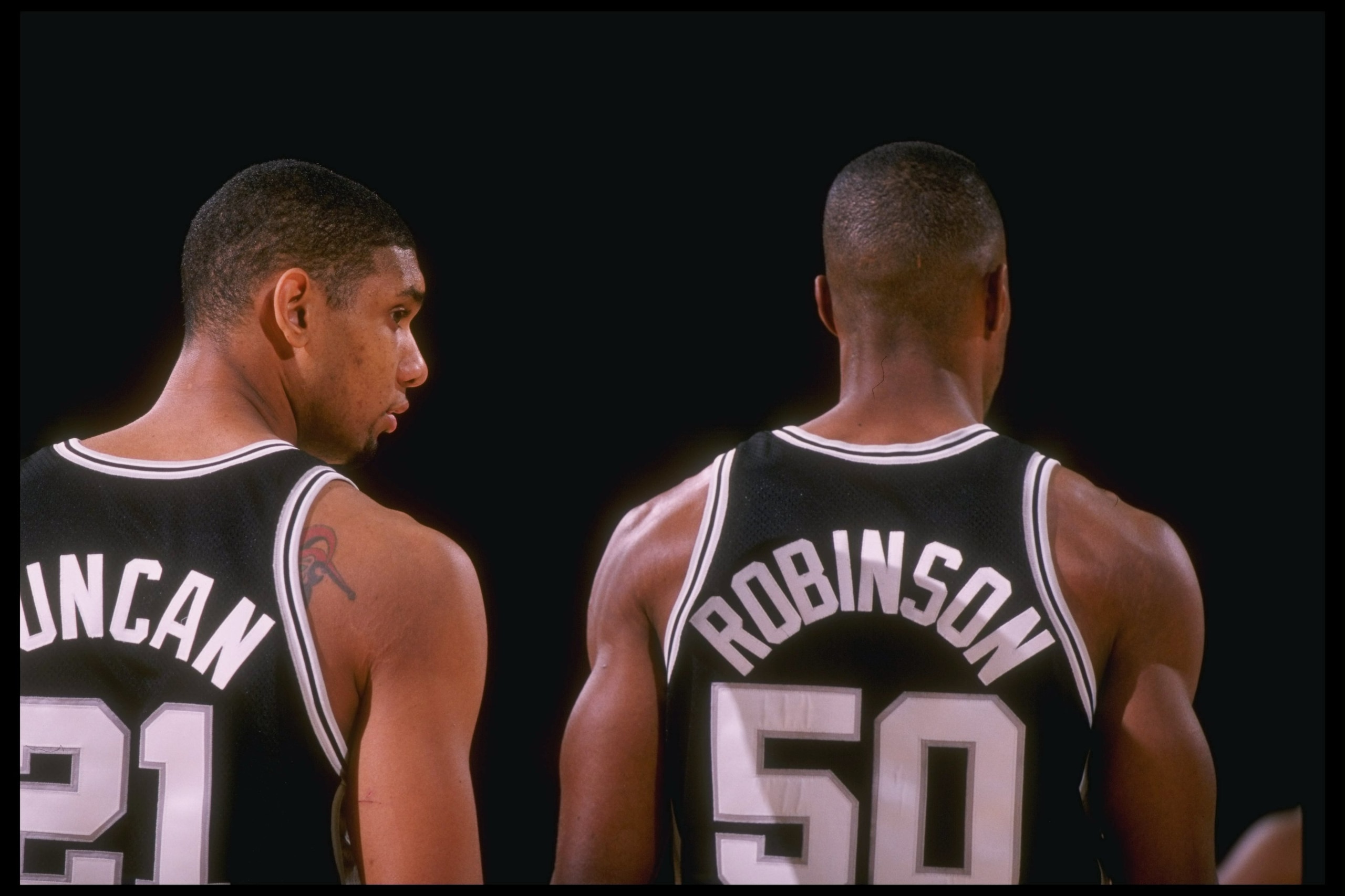 5 Dec 1997:  Centers Tim Duncan and David Robinson of the San Antonio Spurs (right) stand together during a game against the Los Angeles Lakers at the Great Western Forum in Inglewood, California.  The Lakers won the game 98-88. Mandatory Credit: Todd War