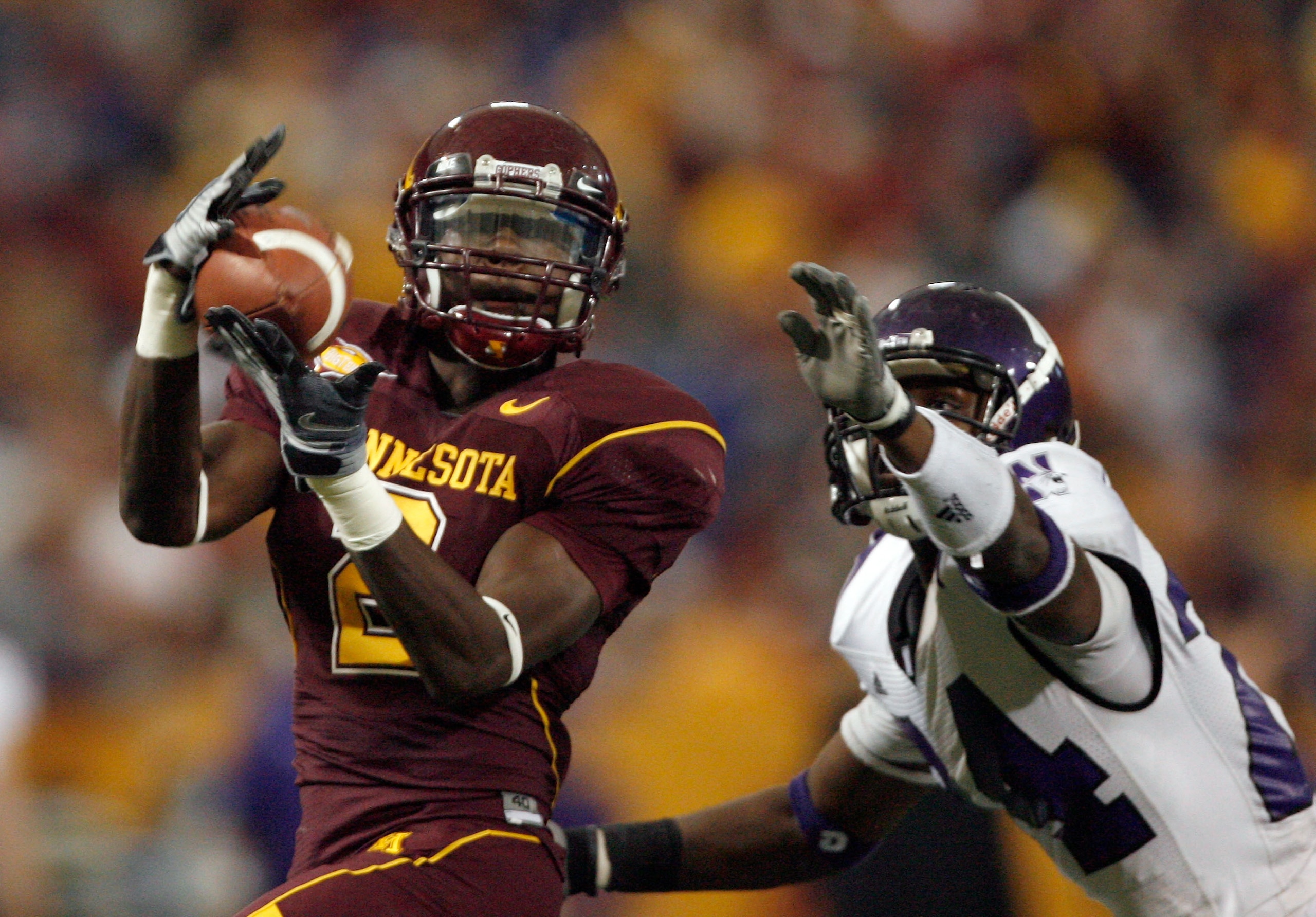 MINNEAPOLIS - NOVEMBER 01:  Brandon Green #2 of the Minnesota Golden Gophers makes a catch in front of Sherrick McManis #26 of the Northwestern Wildcats during the third quarter at the Hubert H.Humphrey Metrodome on November 1, 2008 in Minneapolis, Minnes