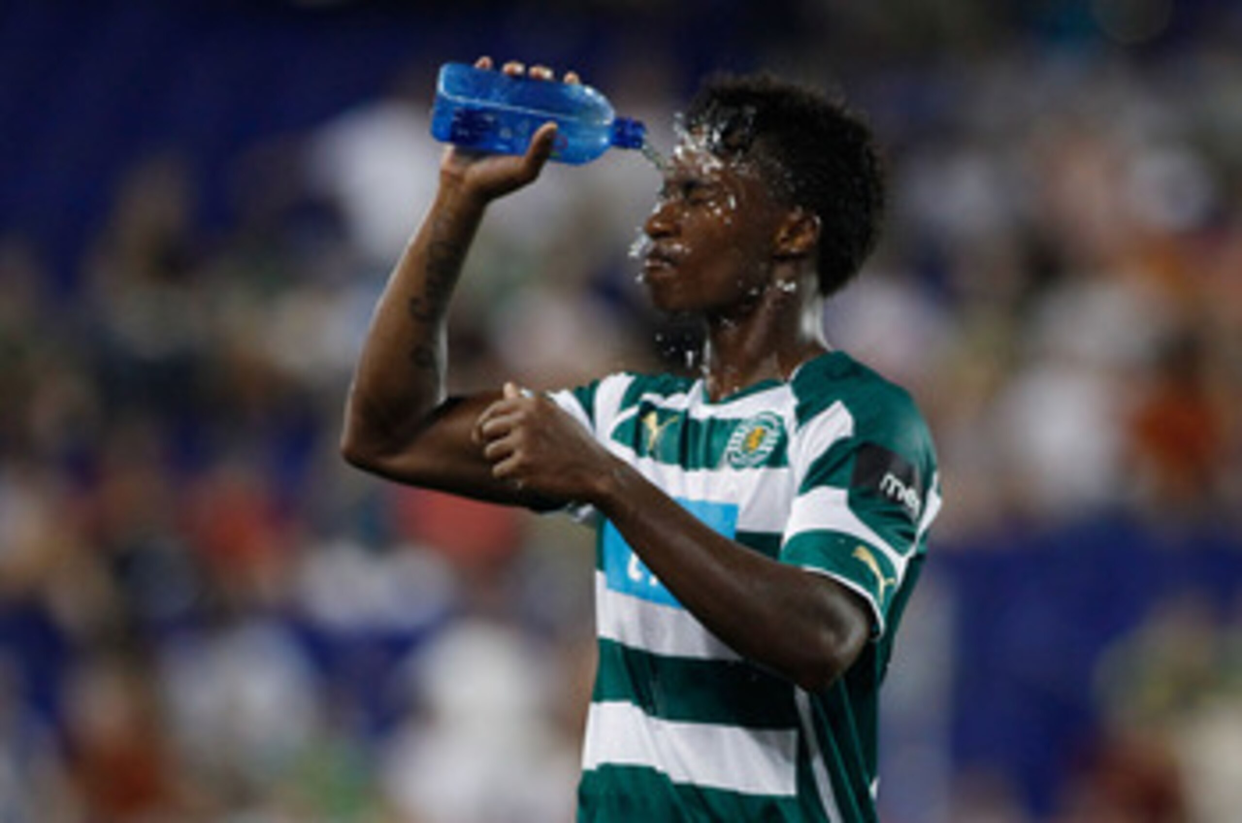 HARRISON, NJ - JULY 23:  Yannick Djalo #20 of Sporting Lisbon cools off during a match against Manchester City in the Barclays New York Challenge July 23, 2010 at Red Bull Arena in Harrison, New Jersey. Sporting Lisbon defeats Manchester City 2-0.  (Photo