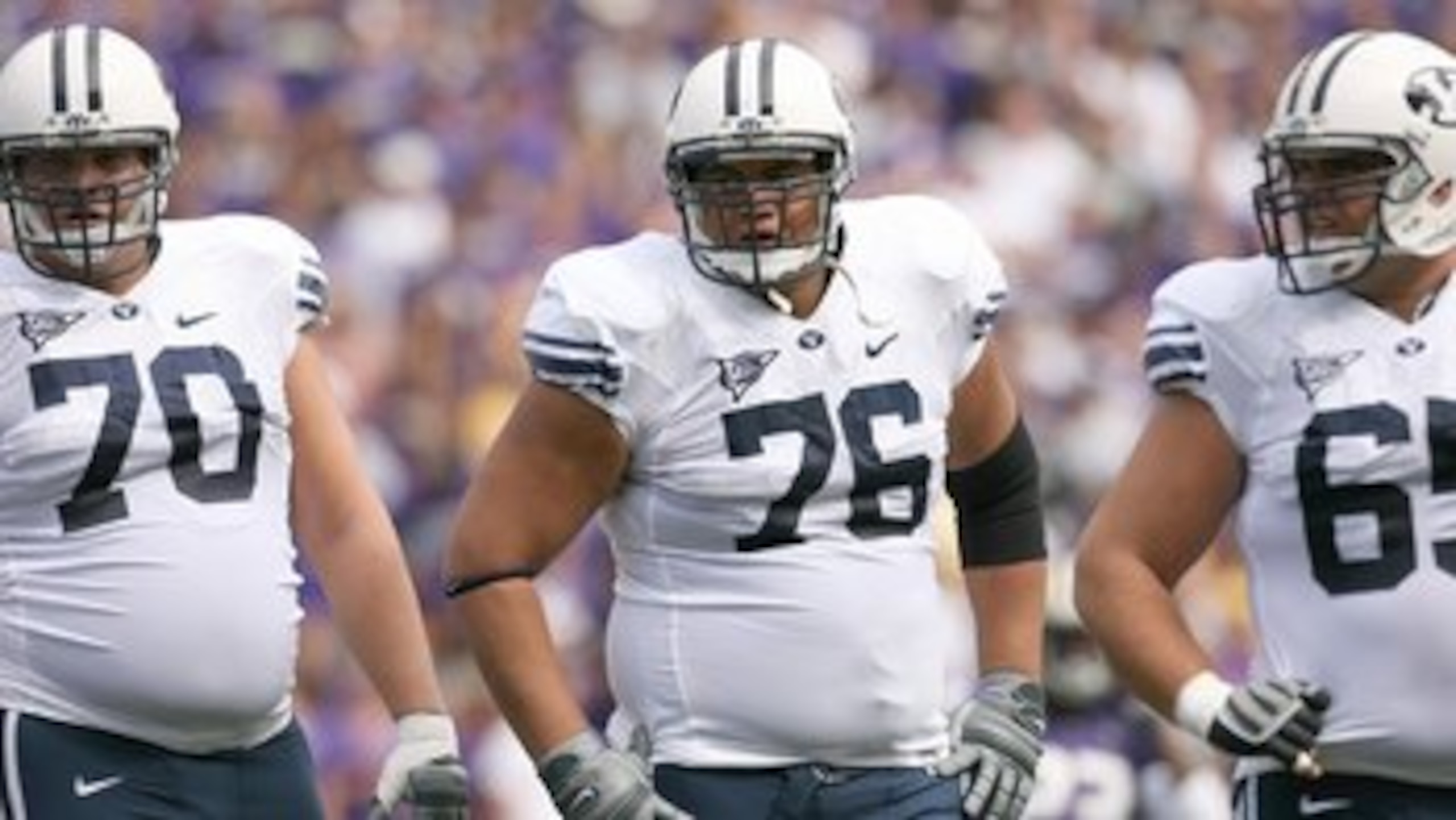 SEATTLE - SEPTEMBER 6:  (L-R) Matt Reynolds #70, Ray Feinga #76 and Dallas Reynolds #65 of the BYU Cougars look on during a break in game action against the Washington Huskies on September 6, 2008 at Husky Stadium in Seattle, Washington. The Cougars defea